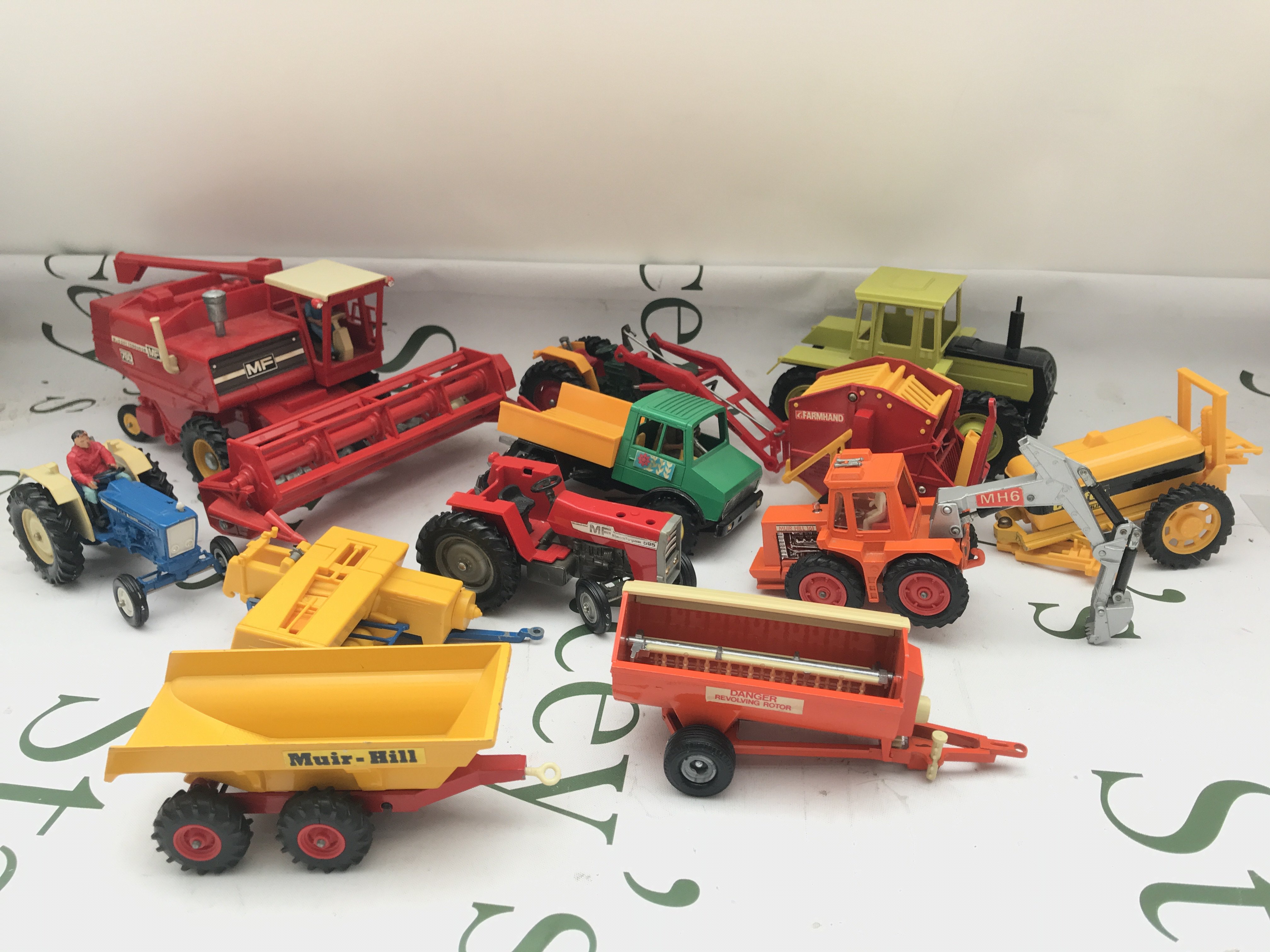 A Collection Of Playworn Farming Machinery And Military Toys.