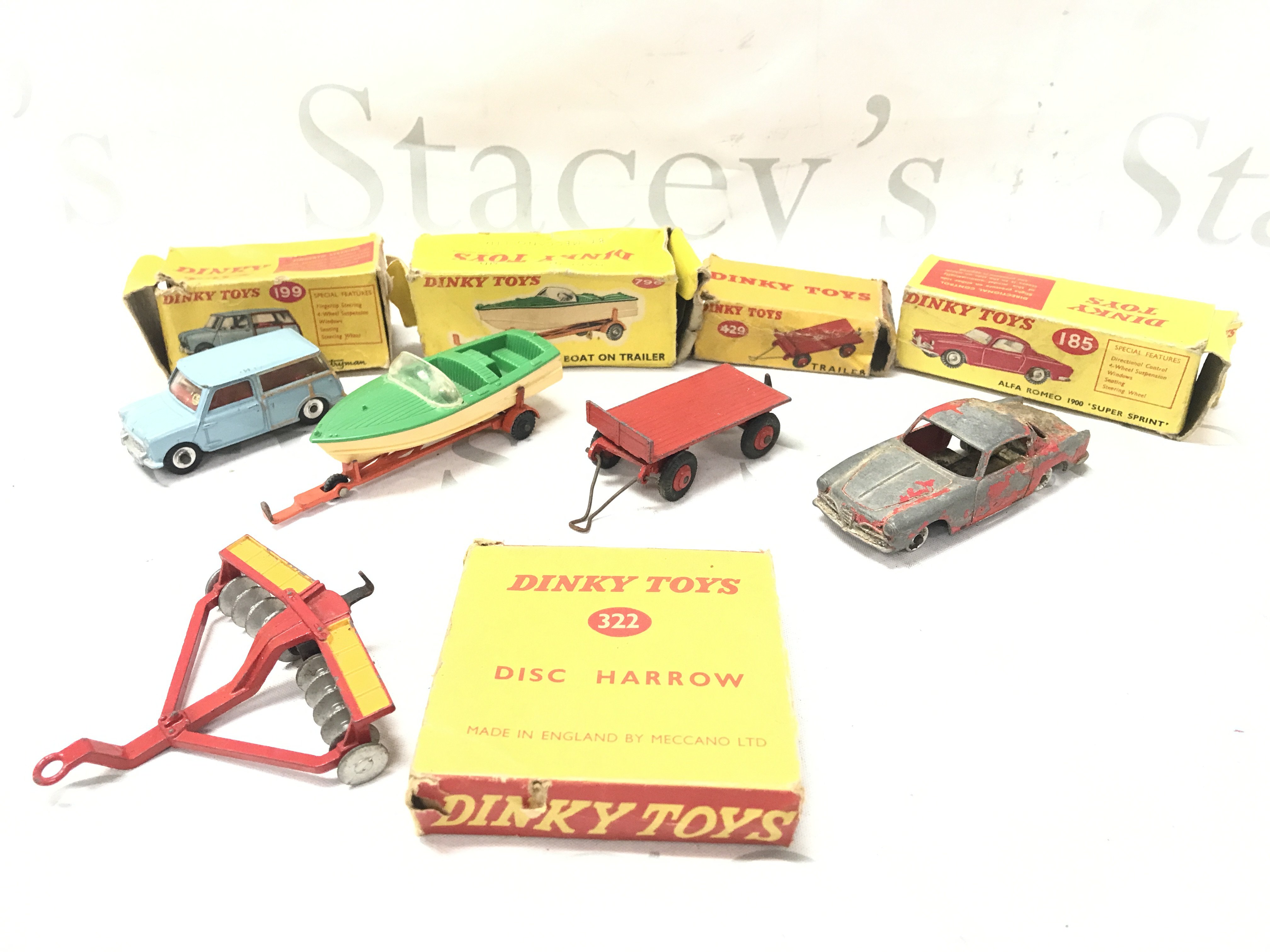 5 Boxed Playworn Dinky Toy. Boxes Are Worn. A Austin Seven #199. A Healey Sports Boat On Trailer #796. A Trailer #429. A Alfa Romeo 1900 #185 And A Disc Harrow #322. No Reserve.