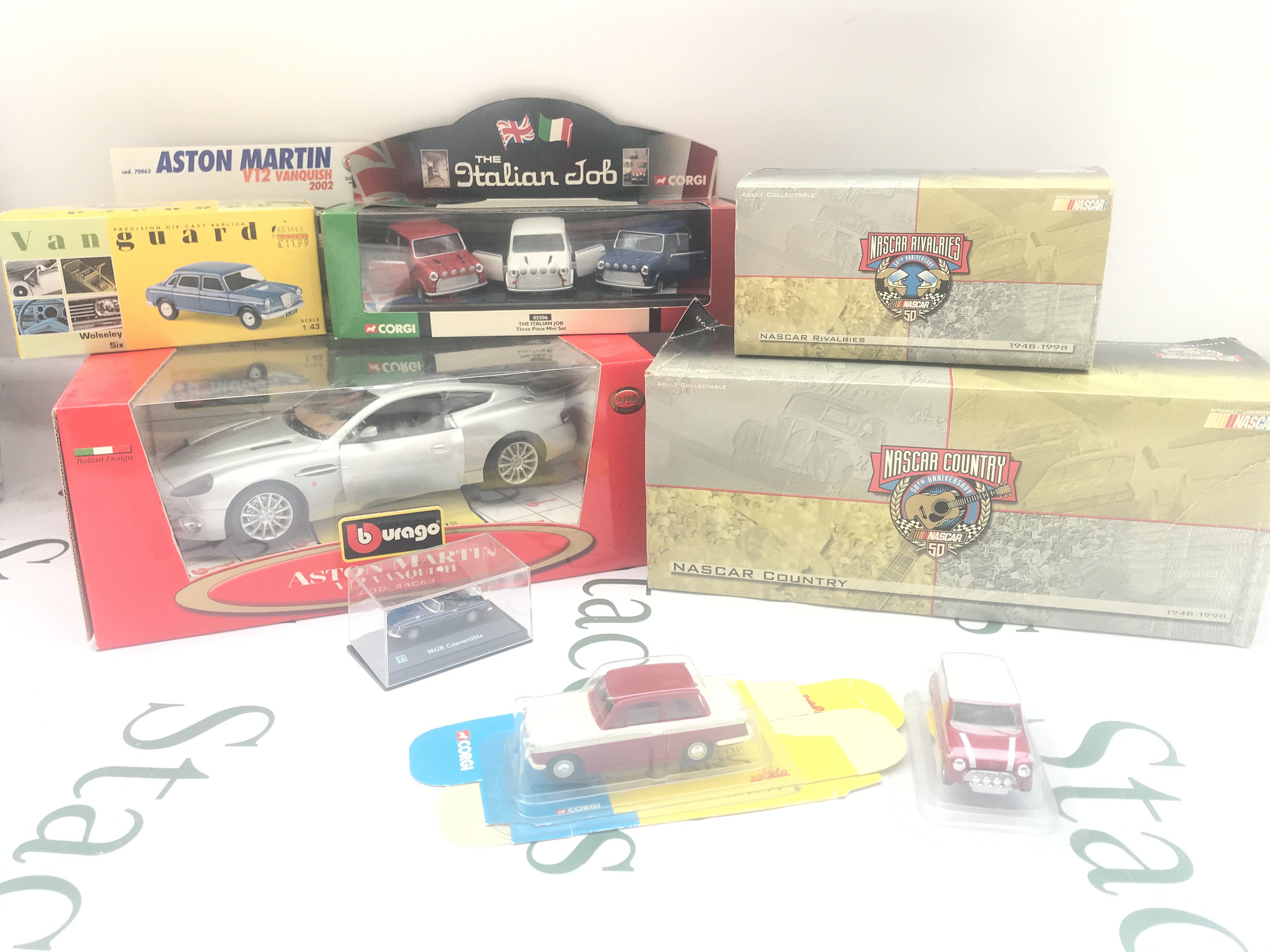 A Collection of Boxed Diecast Including Burago. Corgi. Vanguards And NASCAR.