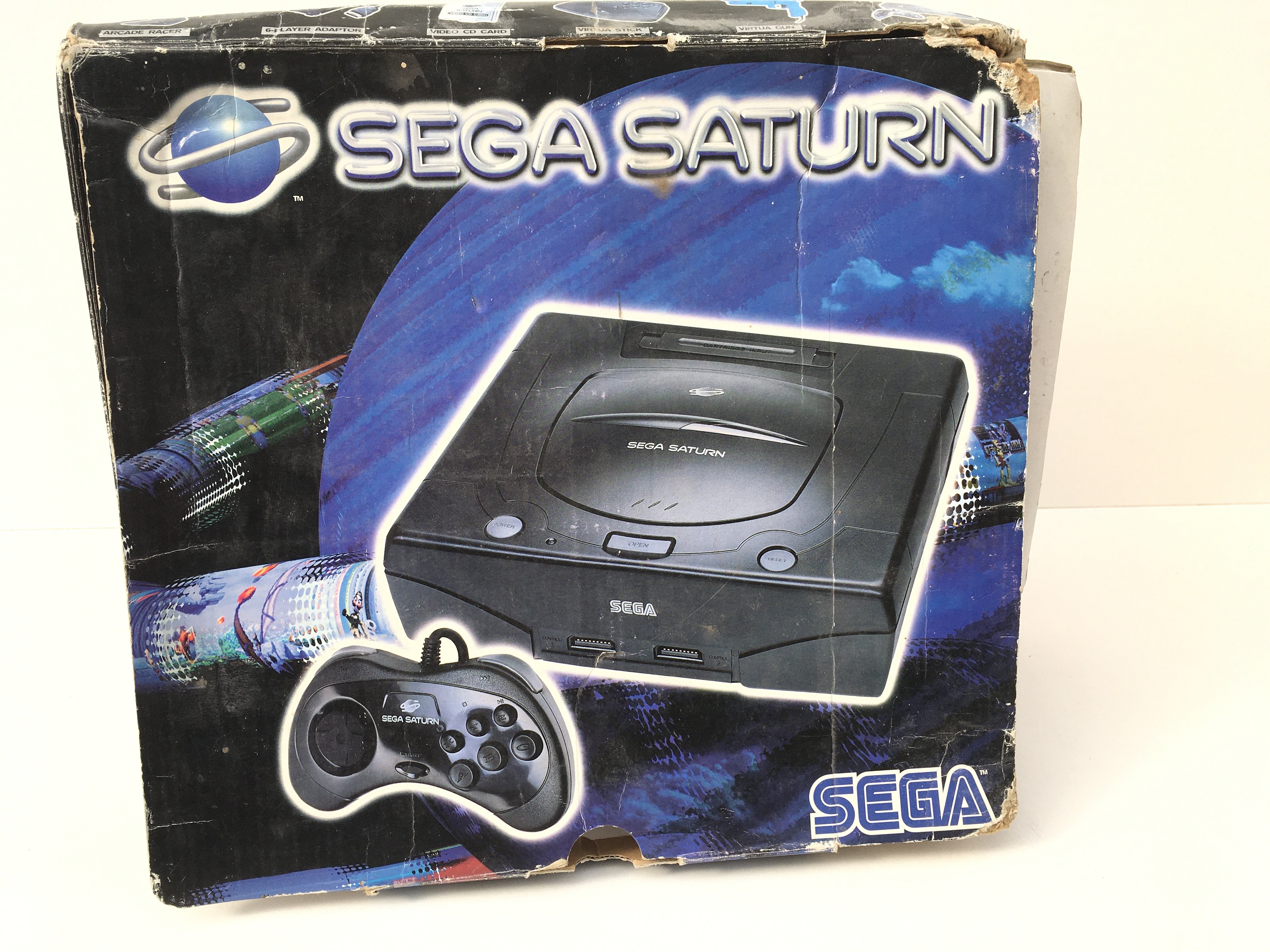 A boxed SEGA SATURN console. Includes controller and cables. No reserve