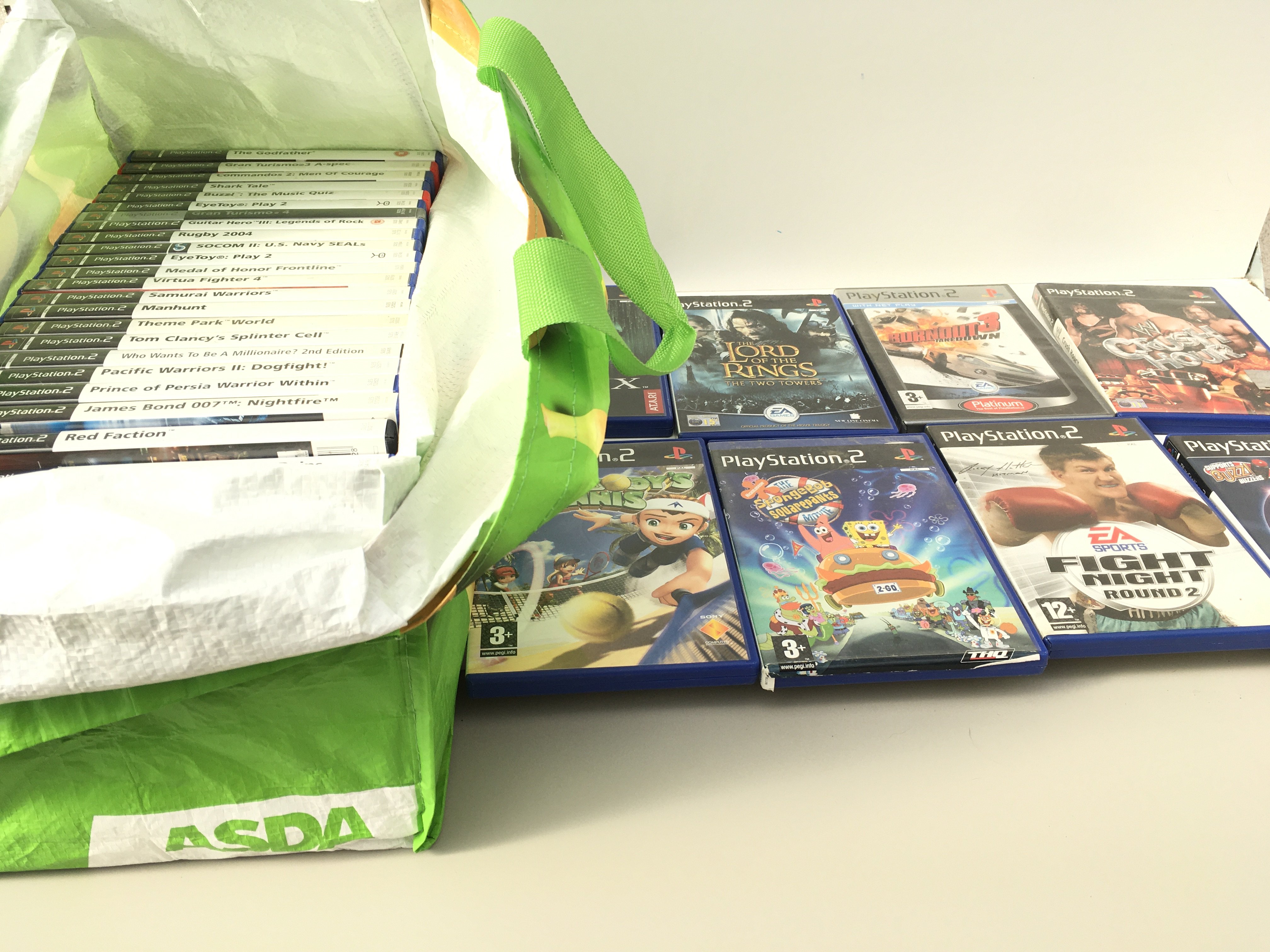 A bag containing in excess of 30 boxed PlayStation 2 games. No reserve
