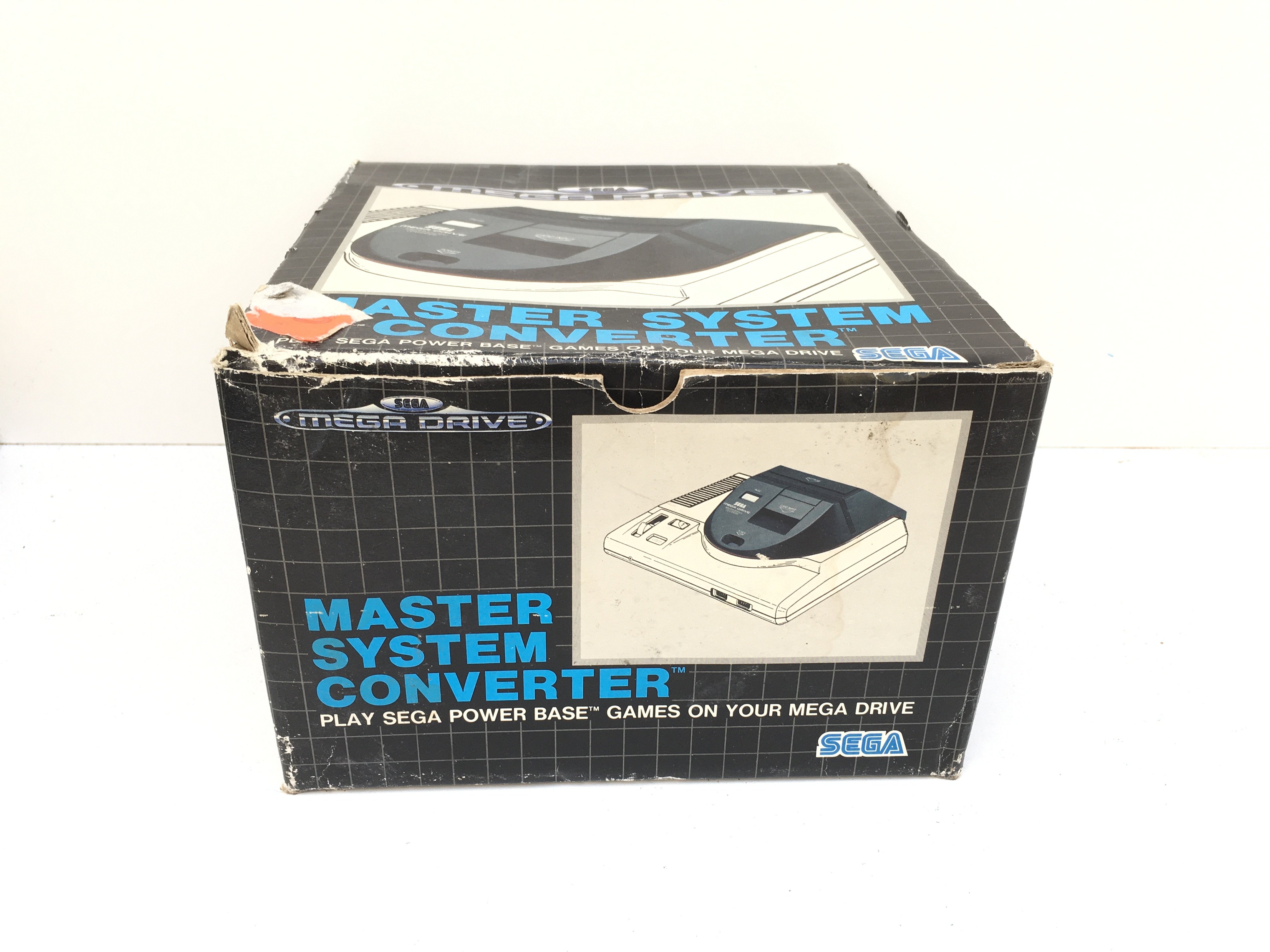 A boxed Sega Mega Drive Master System converter.
