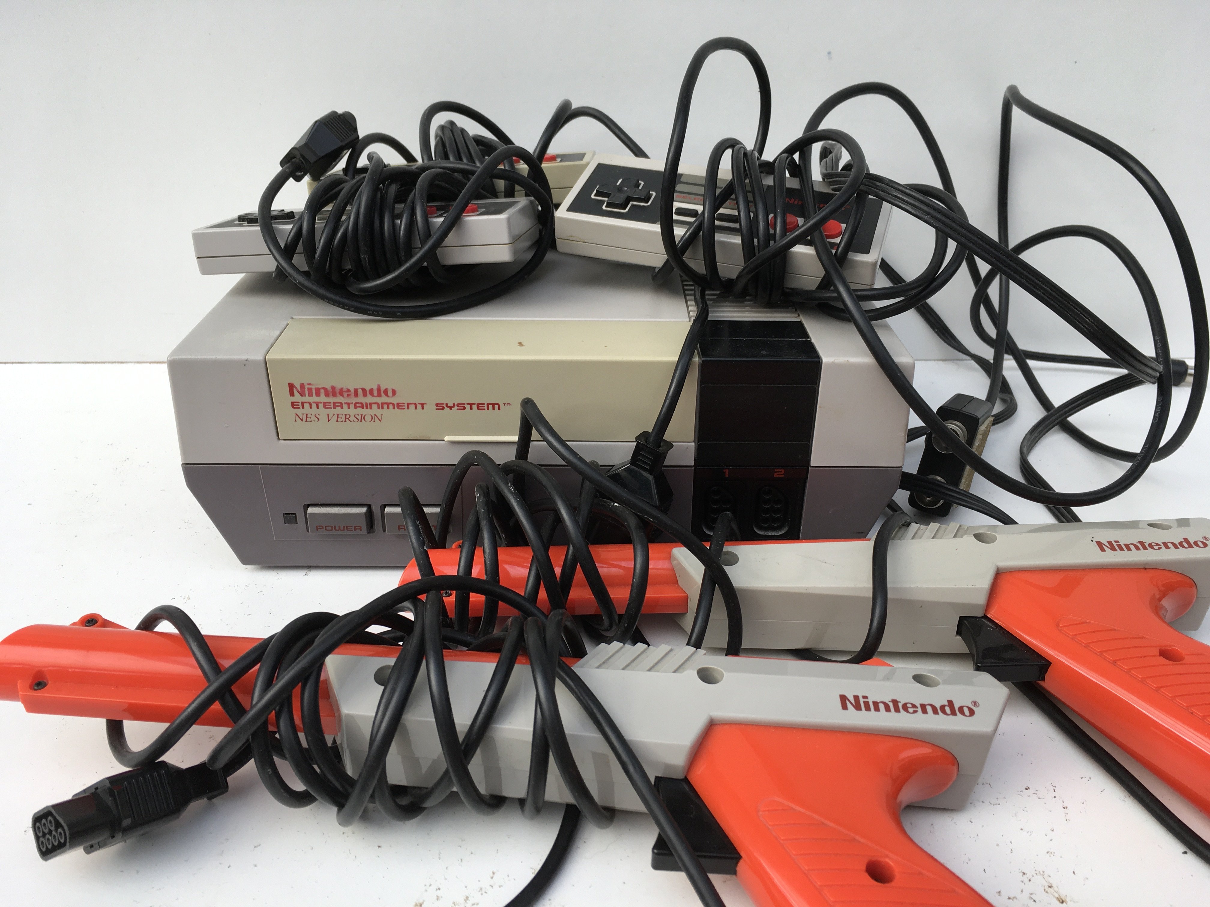 A Nintendo Entertainment System NES Version. Includes controllers..cables..2x Zappers. No reserve