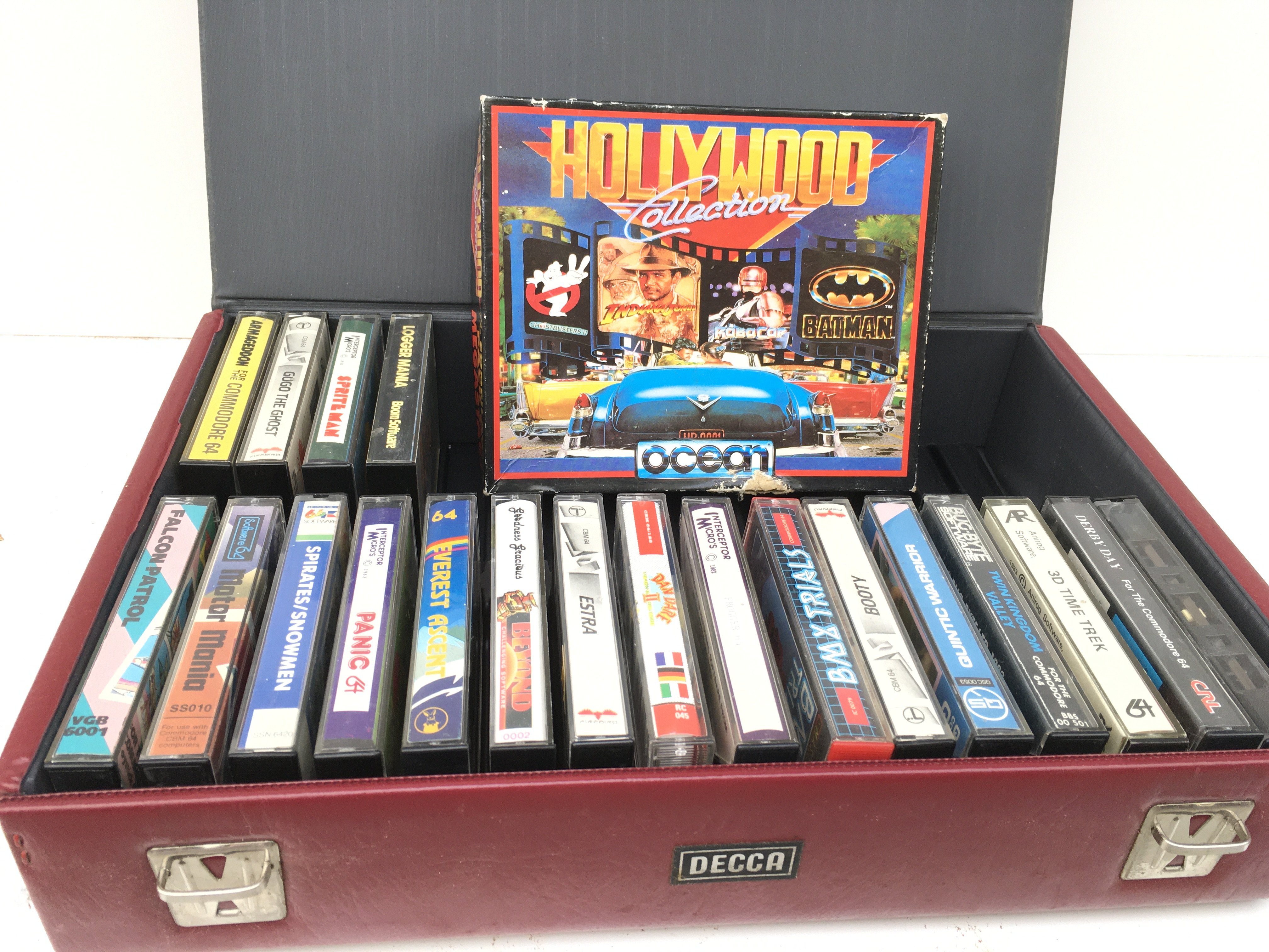 A collection of boxed game cassette tapes for Commodore 64. Includes storage case. No reserve