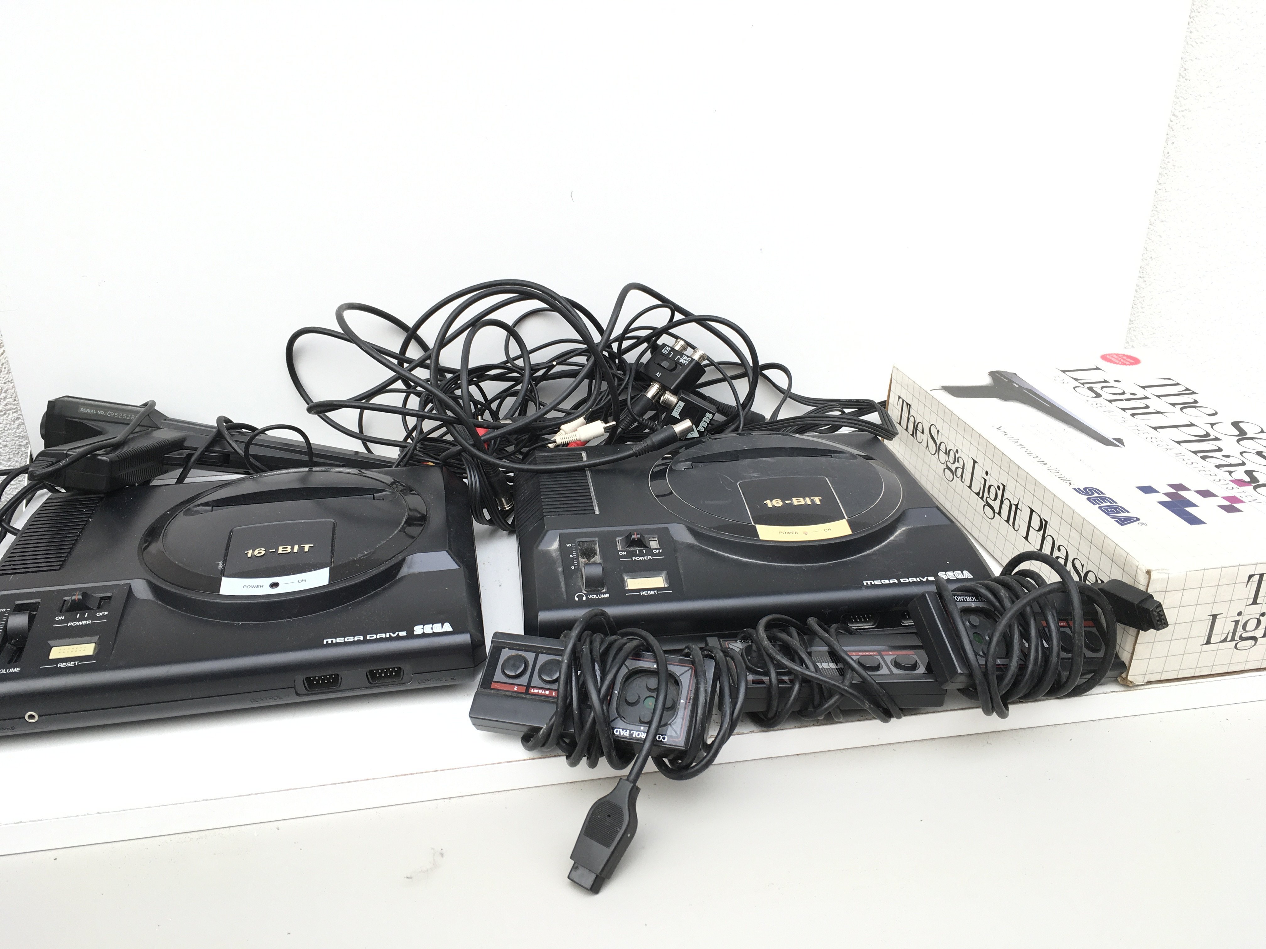 2x SEGA Mega Drive consoles includes control pads..cables ..2 light phasers (1 boxed). No reserve