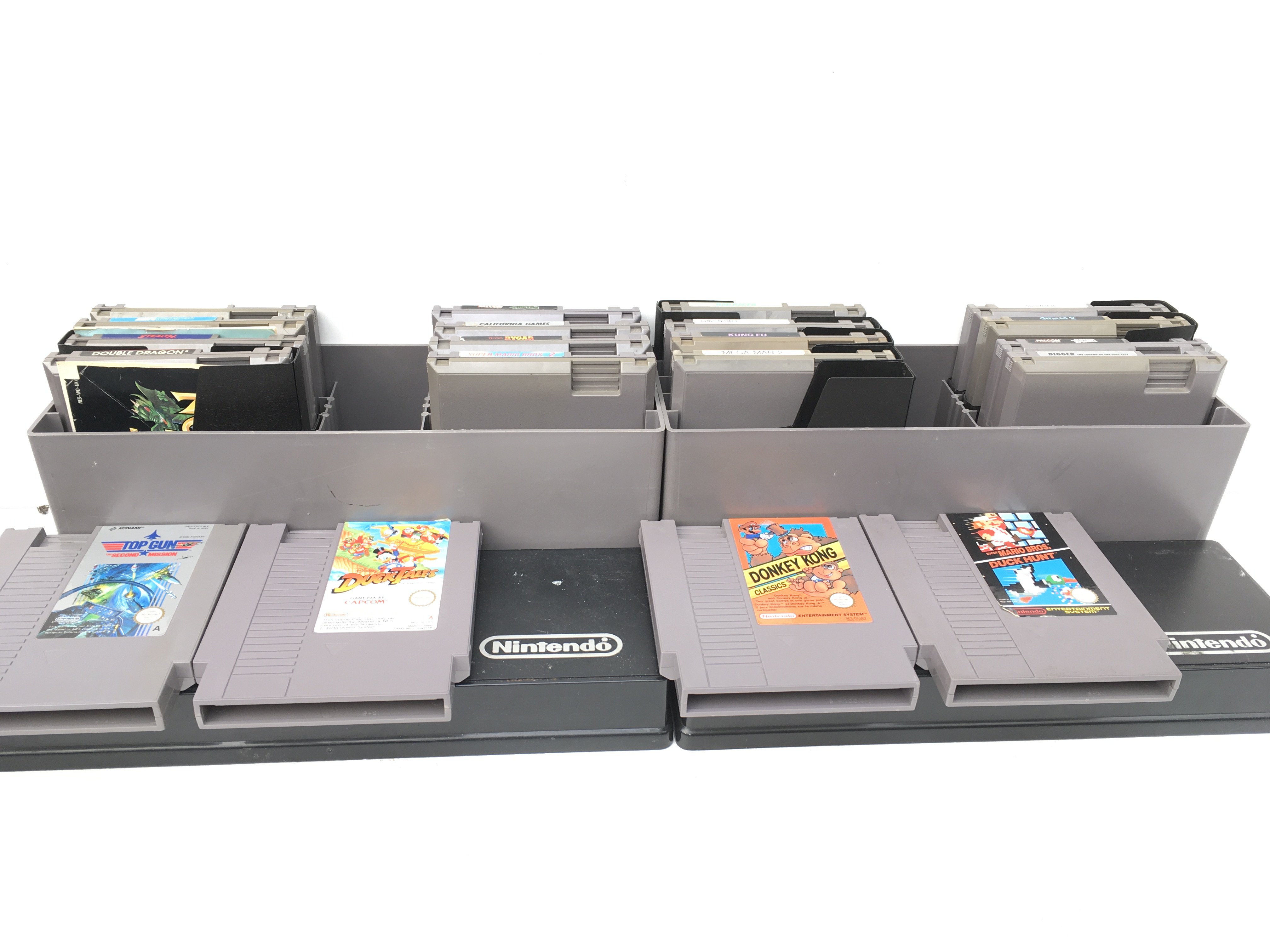 Collection of 20x Nintendo games cartridges in two Nintendo storage boxes. No reserve