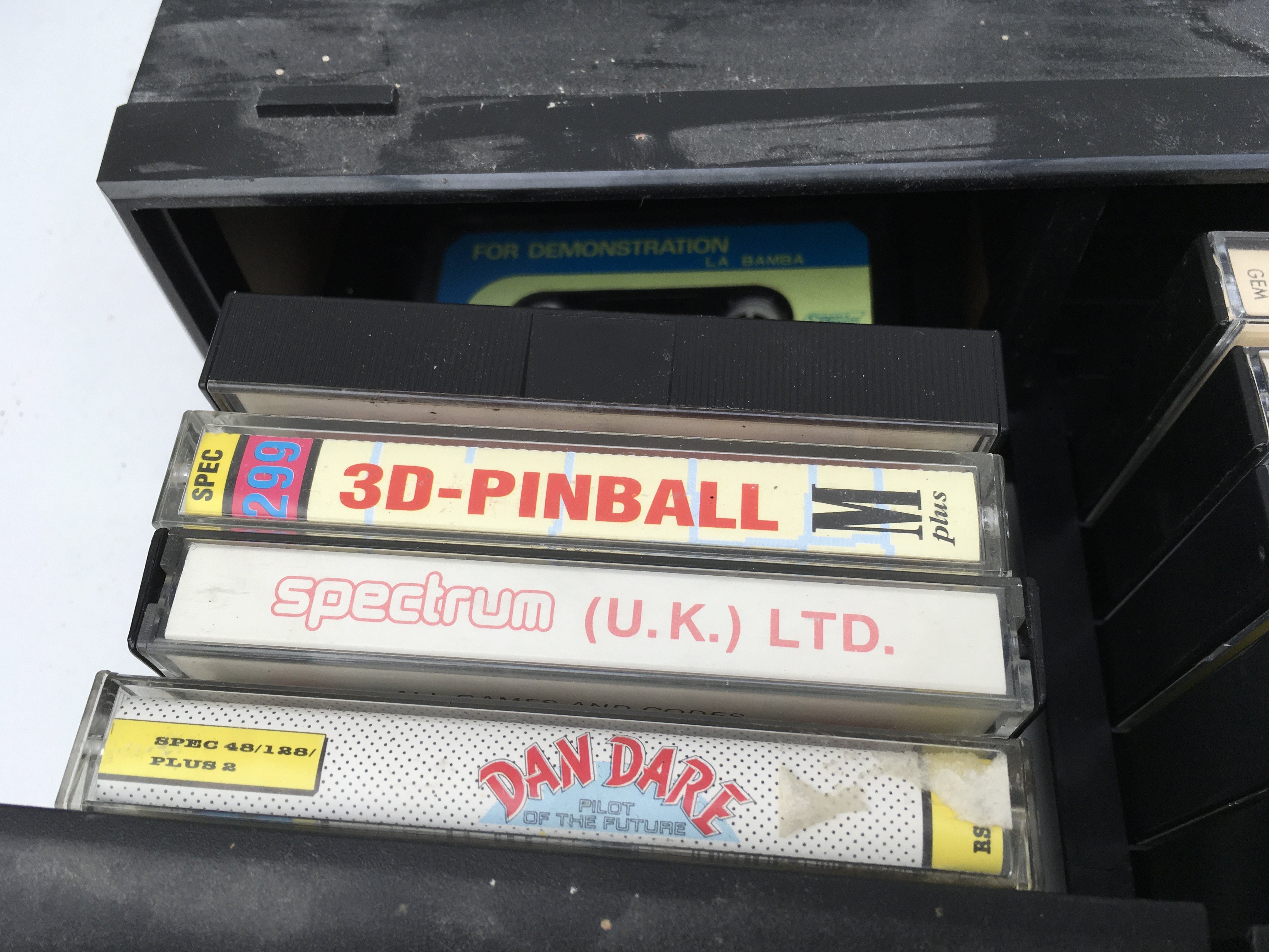 A drawered storage box containing 19 cassettes for use with a Sinclair computer. No reserve