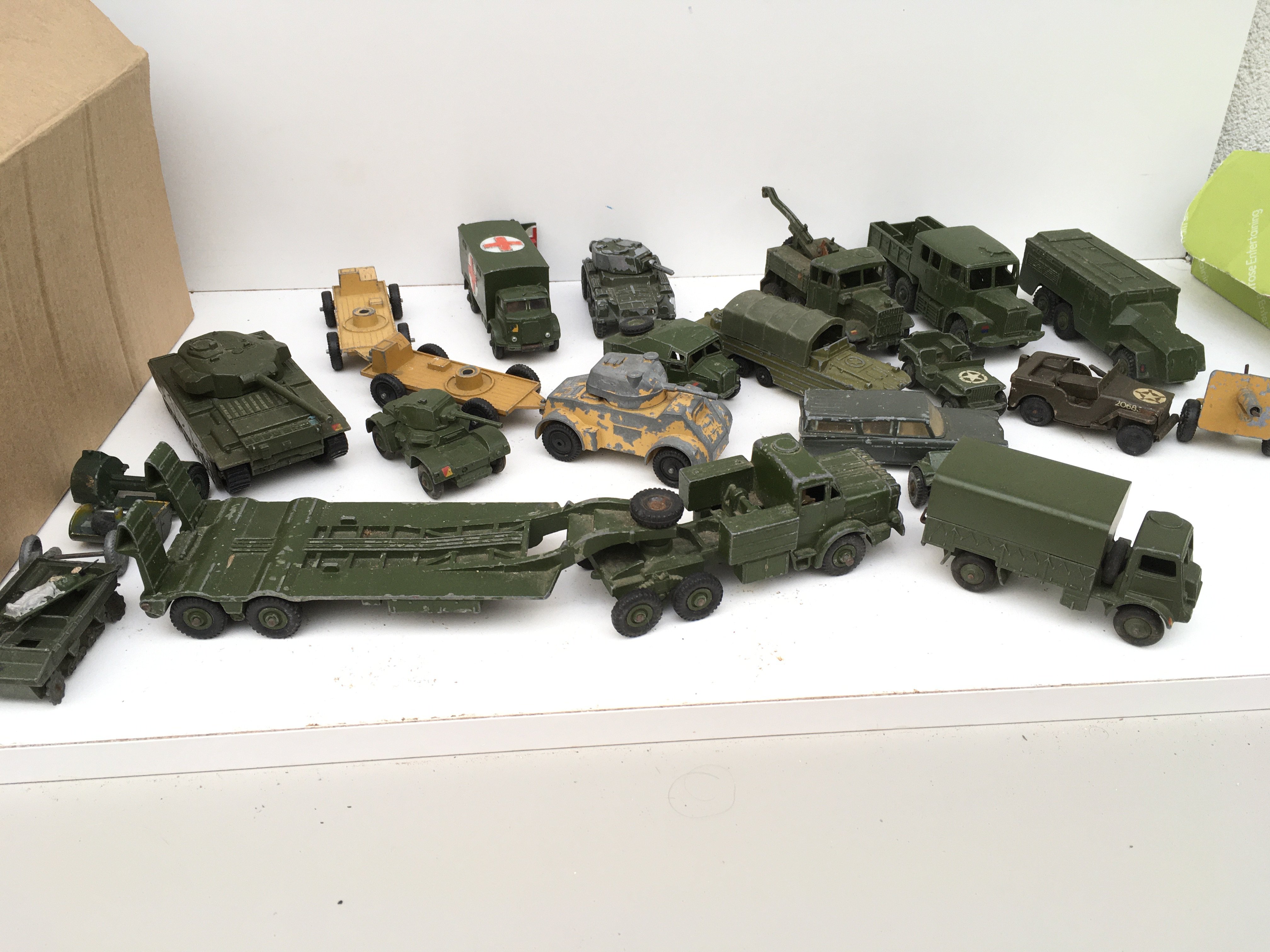 A collection in excess of 15 Playworn military themed diecast vehicles. Manufacturers include Primarily Dinky but some others. No reserve