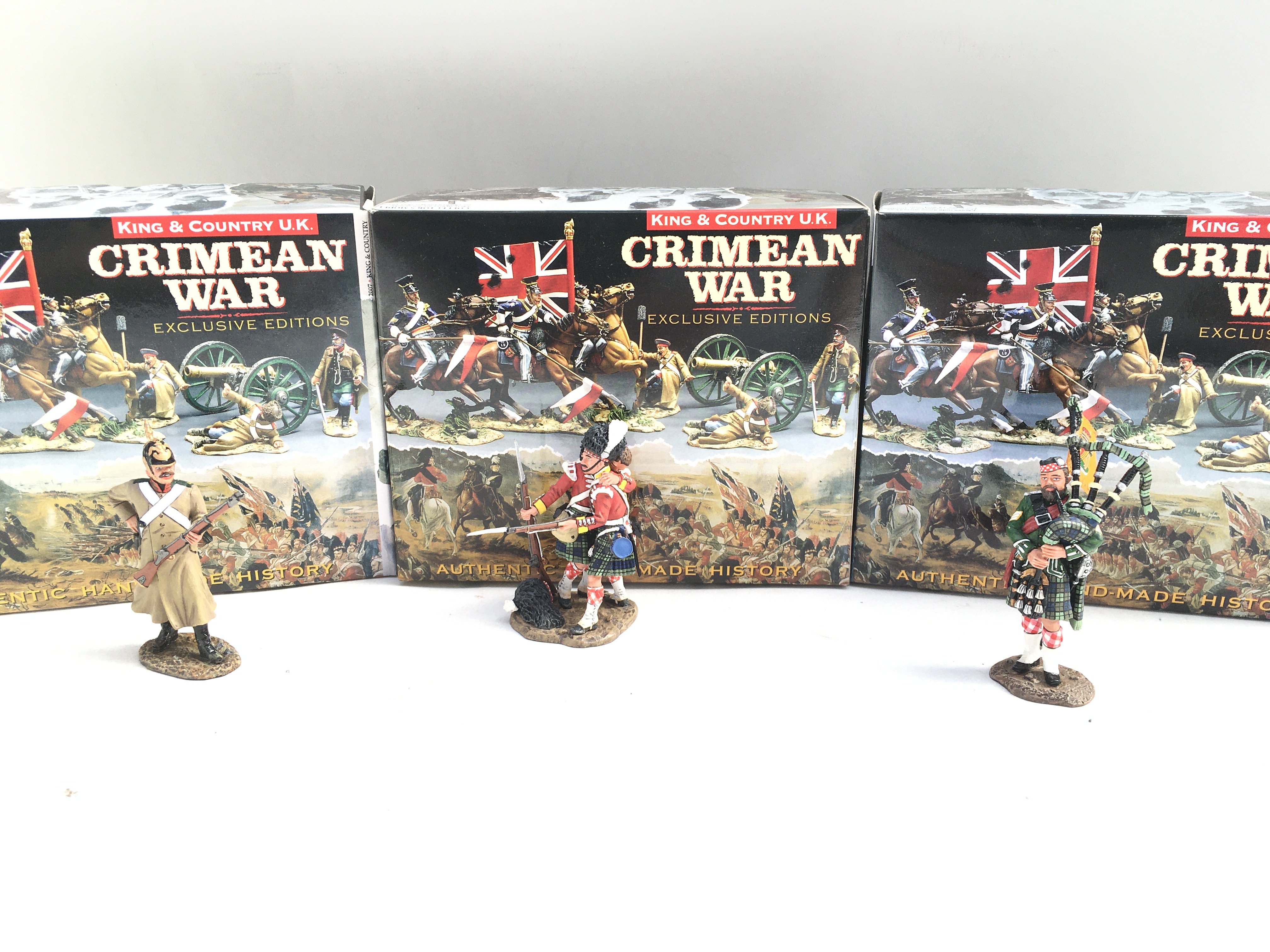3 X Boxed King And Country Crimean Figures.A Russian Standing Loading. Helping A Friend And Highlander Piper.(3)