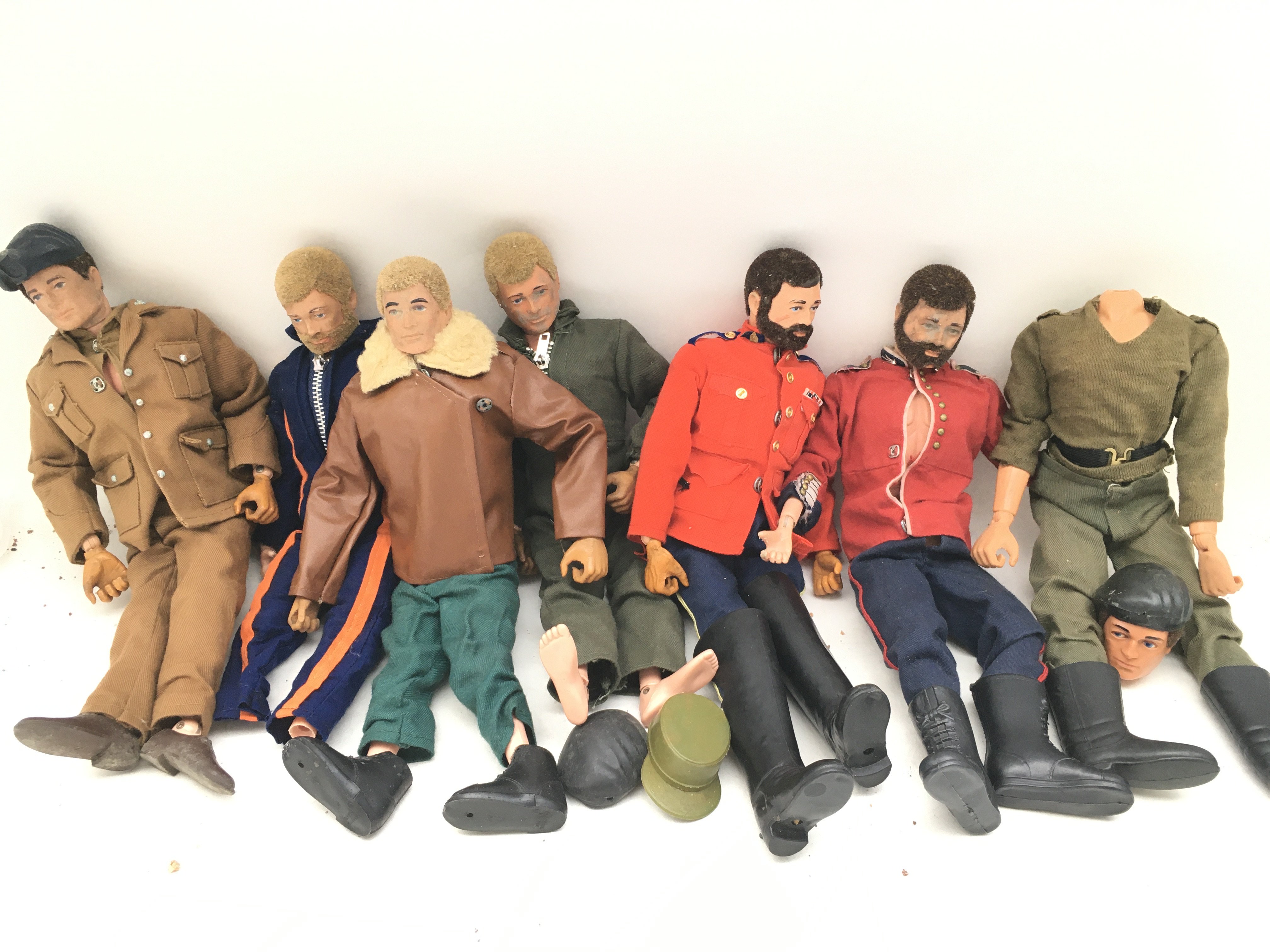A Collection of 7 Playworn Action Men in Various States. No Reserve.