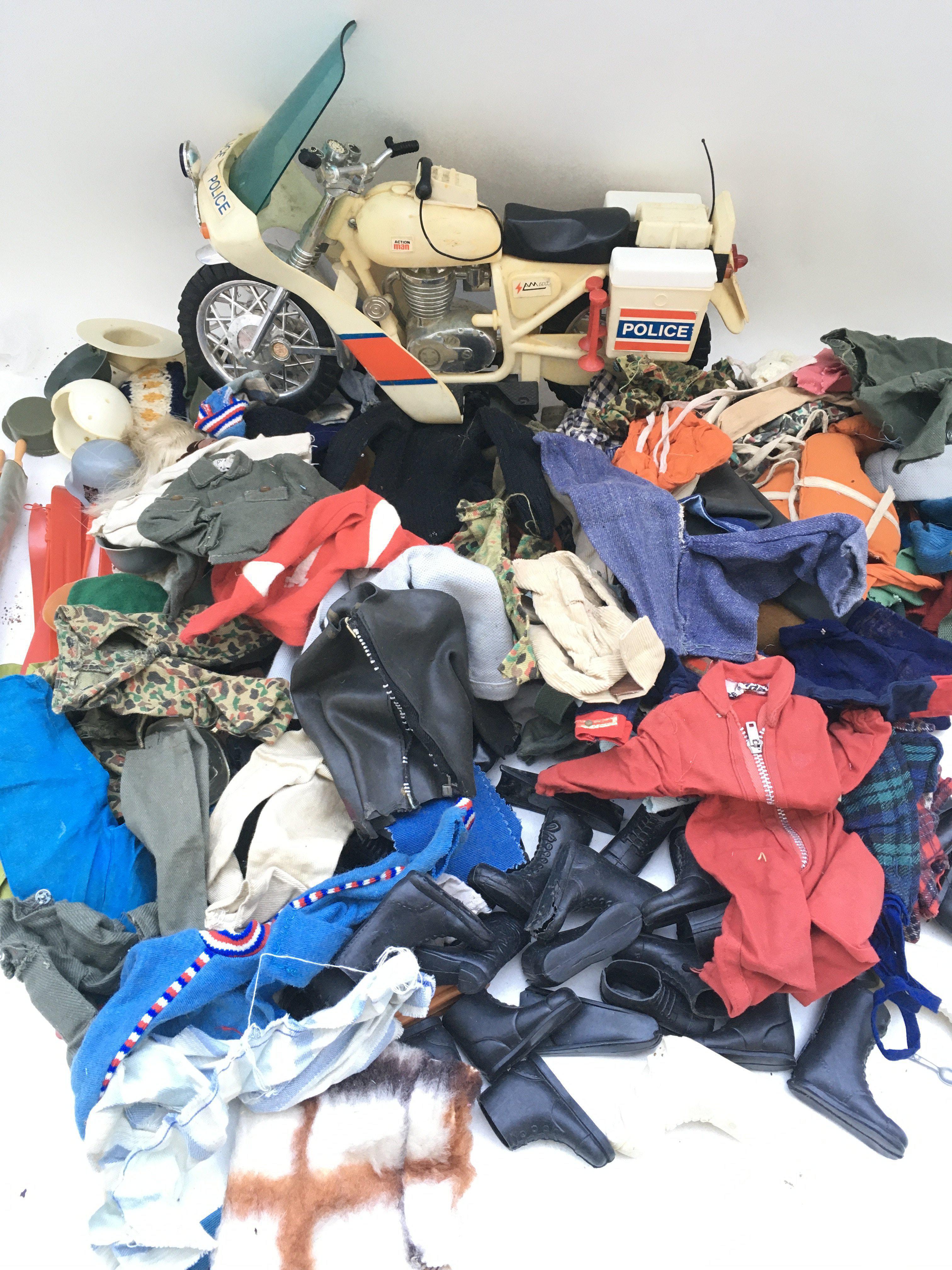 A Collection of Action Man Accessories Including police Motor Bike. Helmets. Boots.uniform.