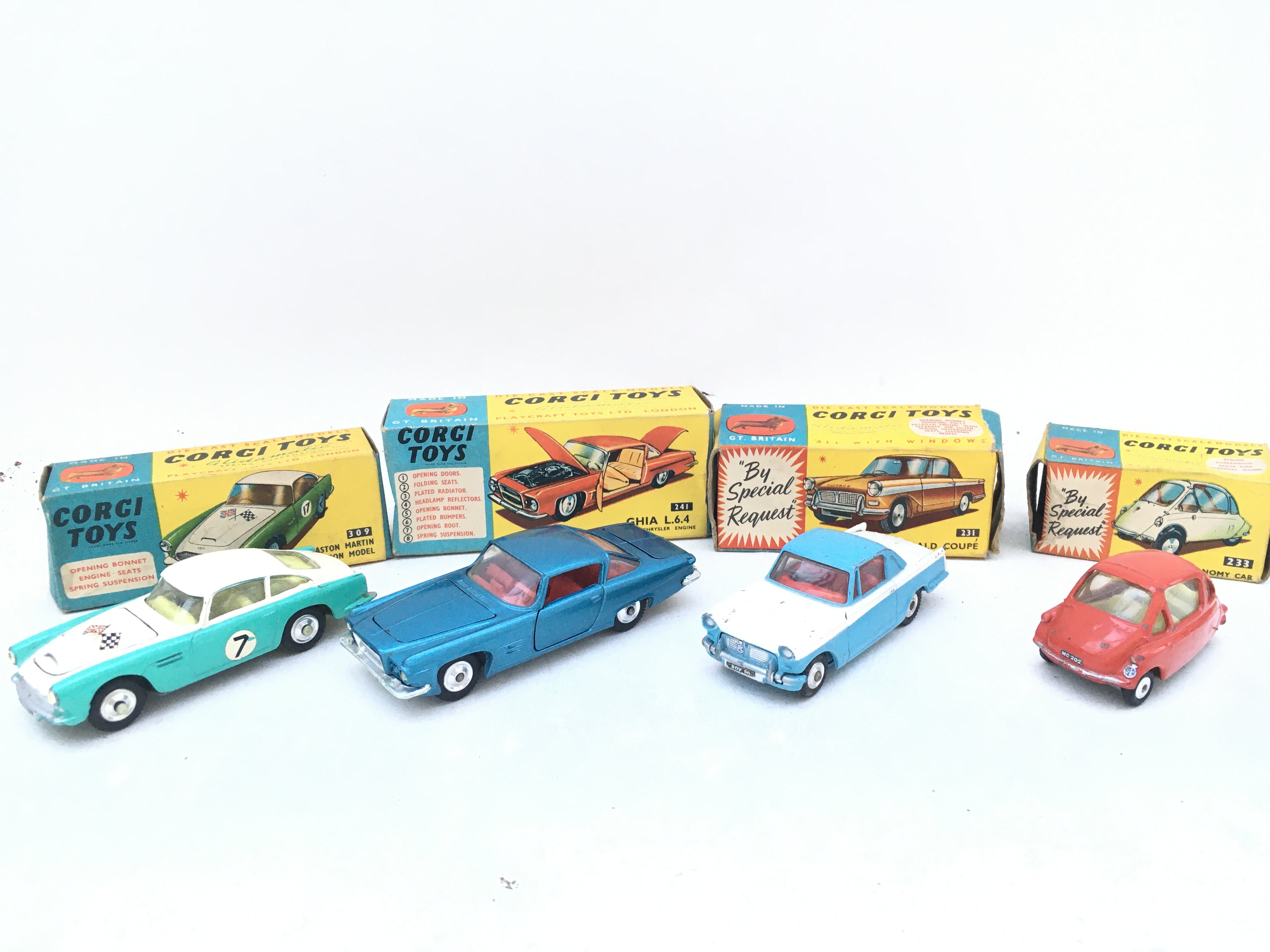4 X Boxed Corgi Vehicles. A Aston Martin Comp #309. A Ghia L.6.4 #241. A Triumph Herald Coupe #231 And A Heinkel Economy Car #233.