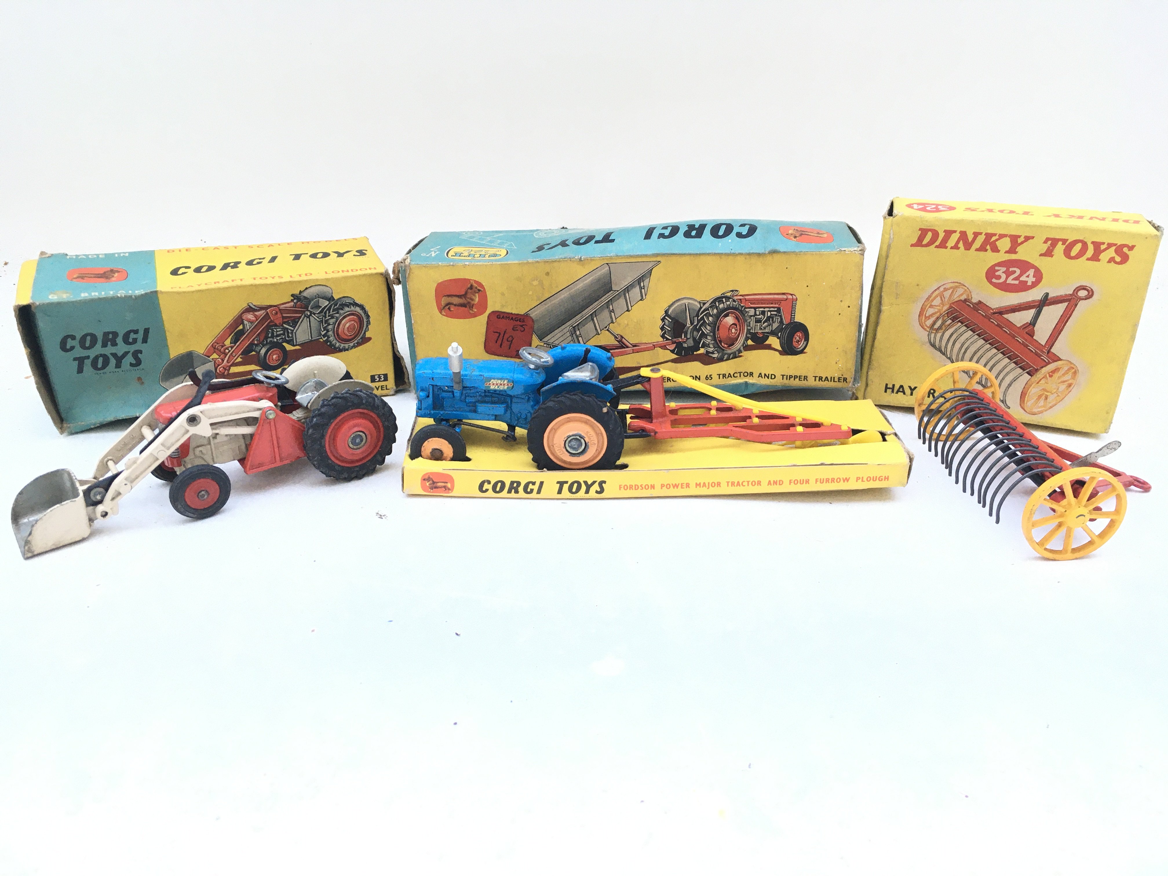 A Boxed Corgi Massey-Ferguson Tractor With Shovel #53. A Massey Ferguson 65 Tractor And Tipper Trailer # gift Set 7 And A Dinky Hay Rake #324.