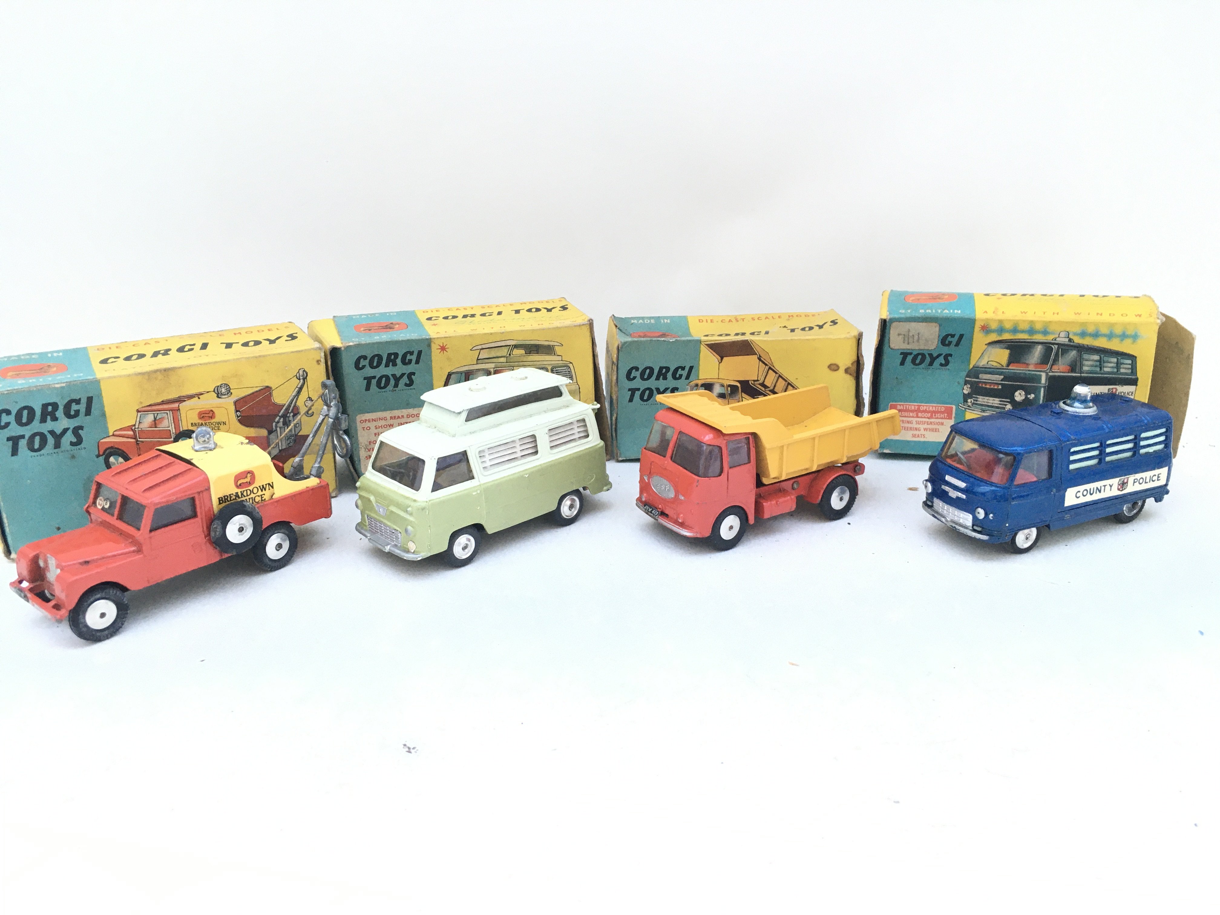 4 X Boxed Corgi Vehicles. A Land-Rover Breakdown Truck #427. A Ford Thames Airborne Truck #420. An E.R.F. Model64G #458 And A Commer Police Van #464.