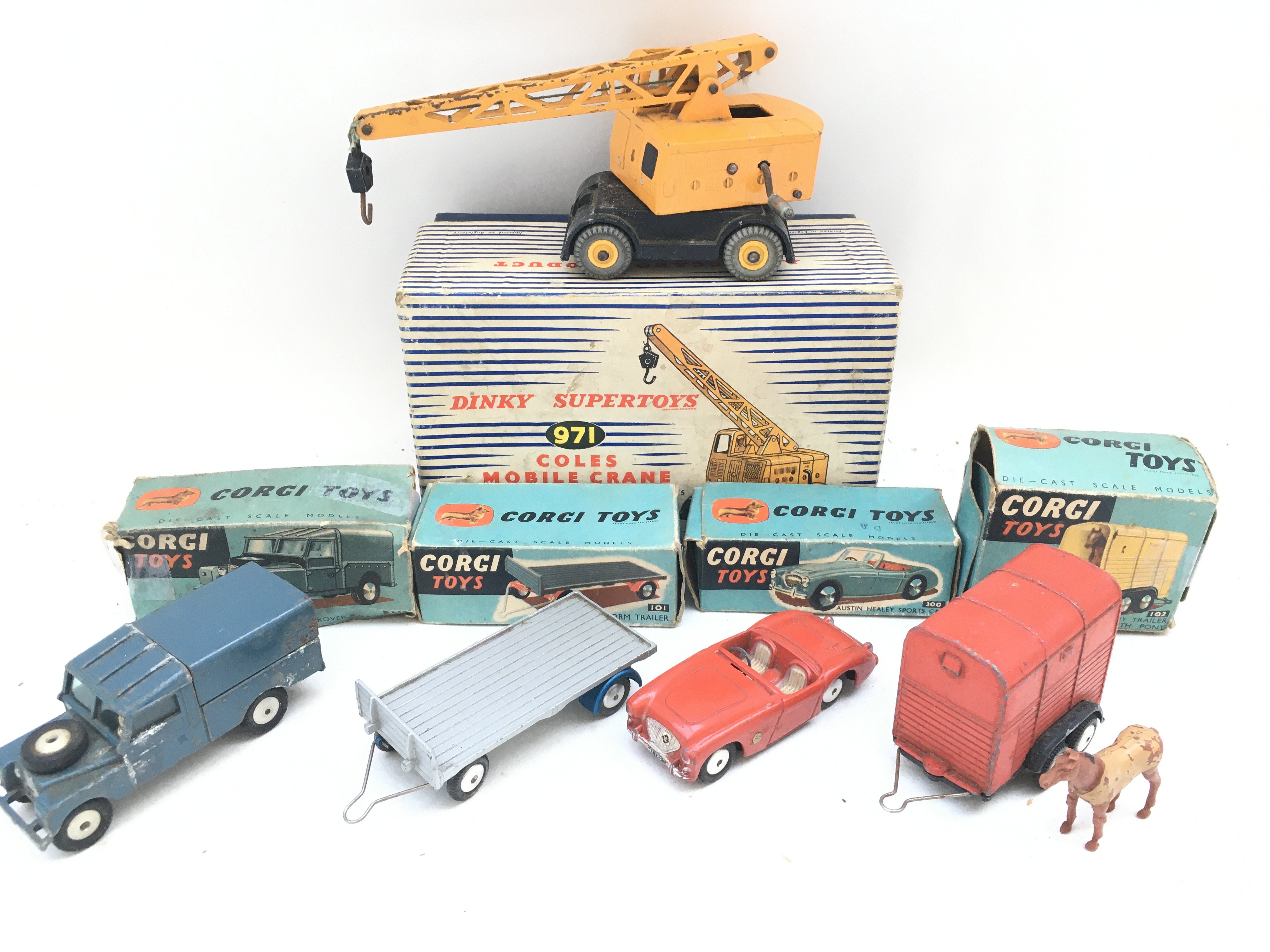 4 Boxed Corgi Vehicles and a Dinky Coles Mobile Crane. Boxes And Vehicles aim Various States.