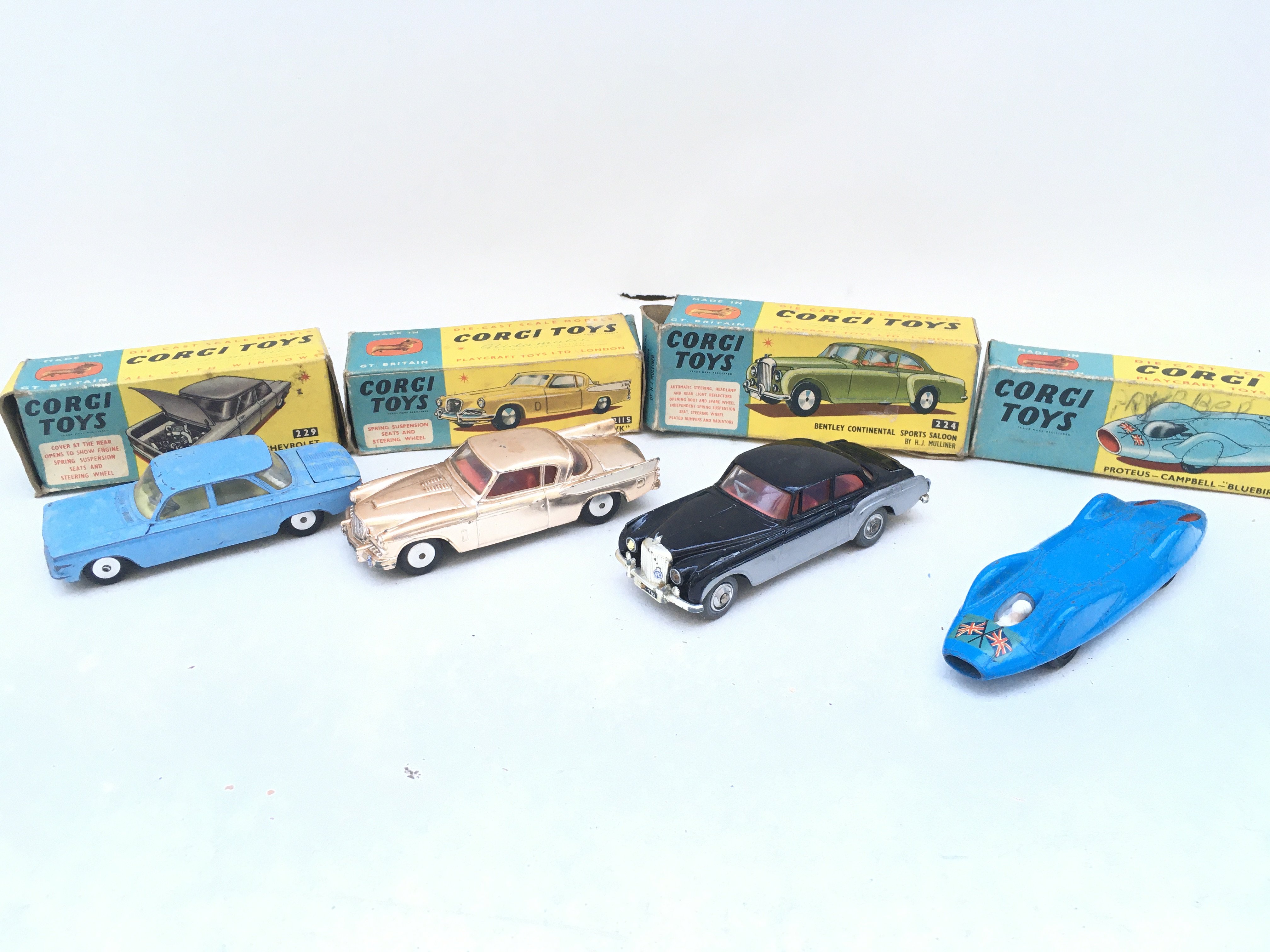 4 Boxed Corgi Vehicles. A Chevrolet Corvair #229 A Studebaker Golden Hawk #2115. A Bentley Continental Sports Saloon #224 And A Proteus-Campbell Bluebird Record Car #153.
