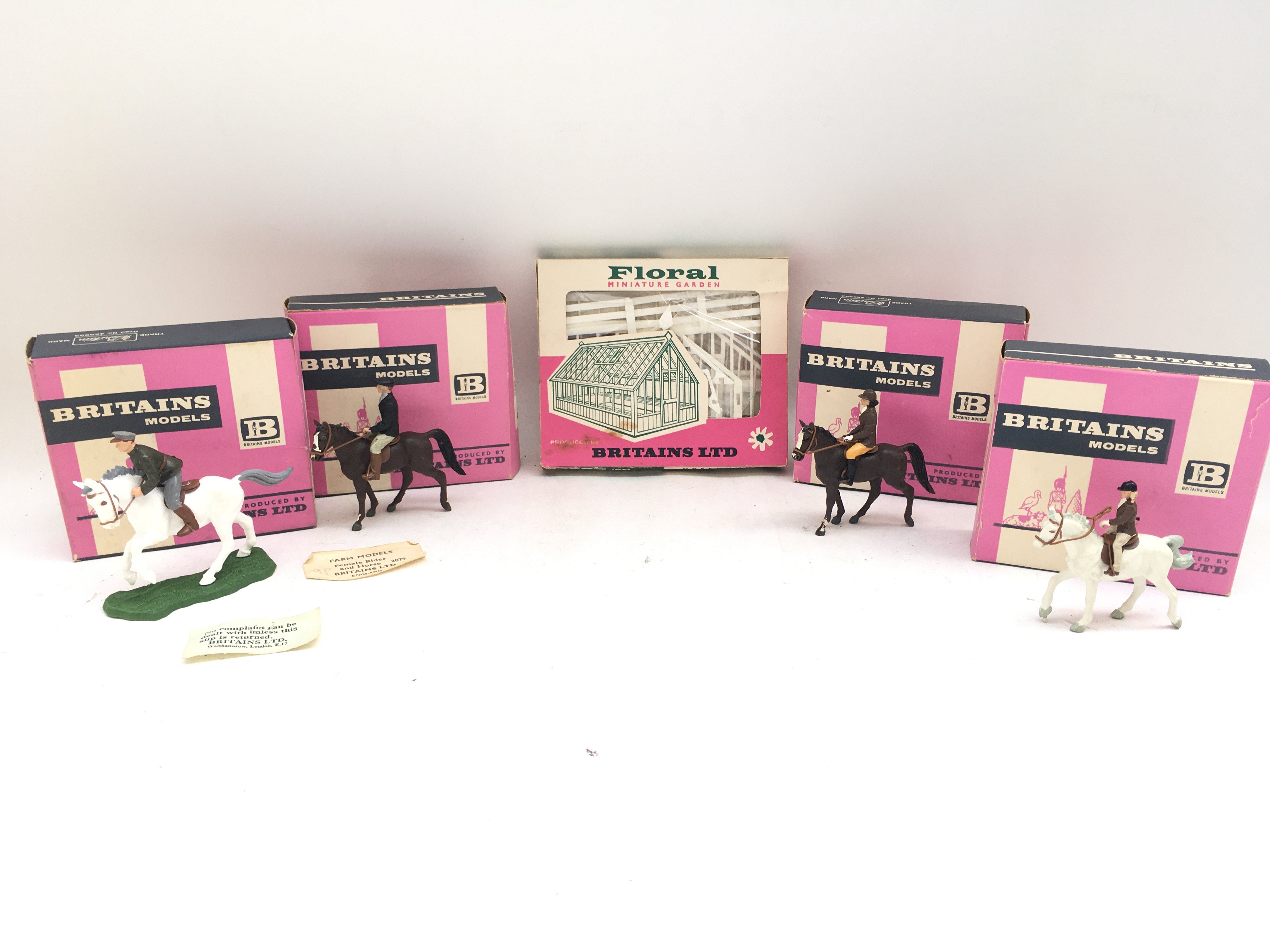 A Collection of 5 Boxed Britains. 4 Horse Riders And A Miniature Garden.