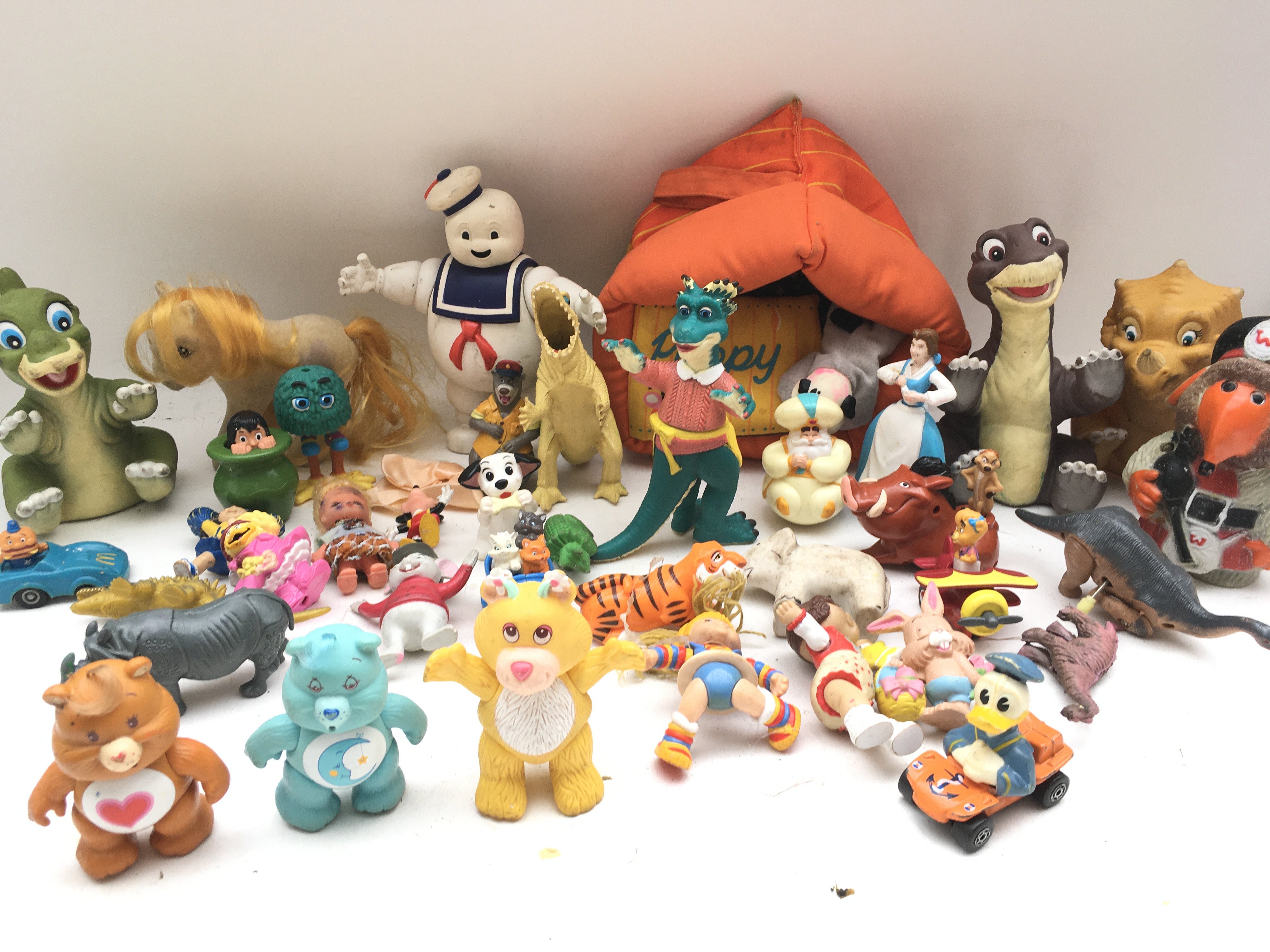 A Collection of Various Toys and Figures includes Care bears.