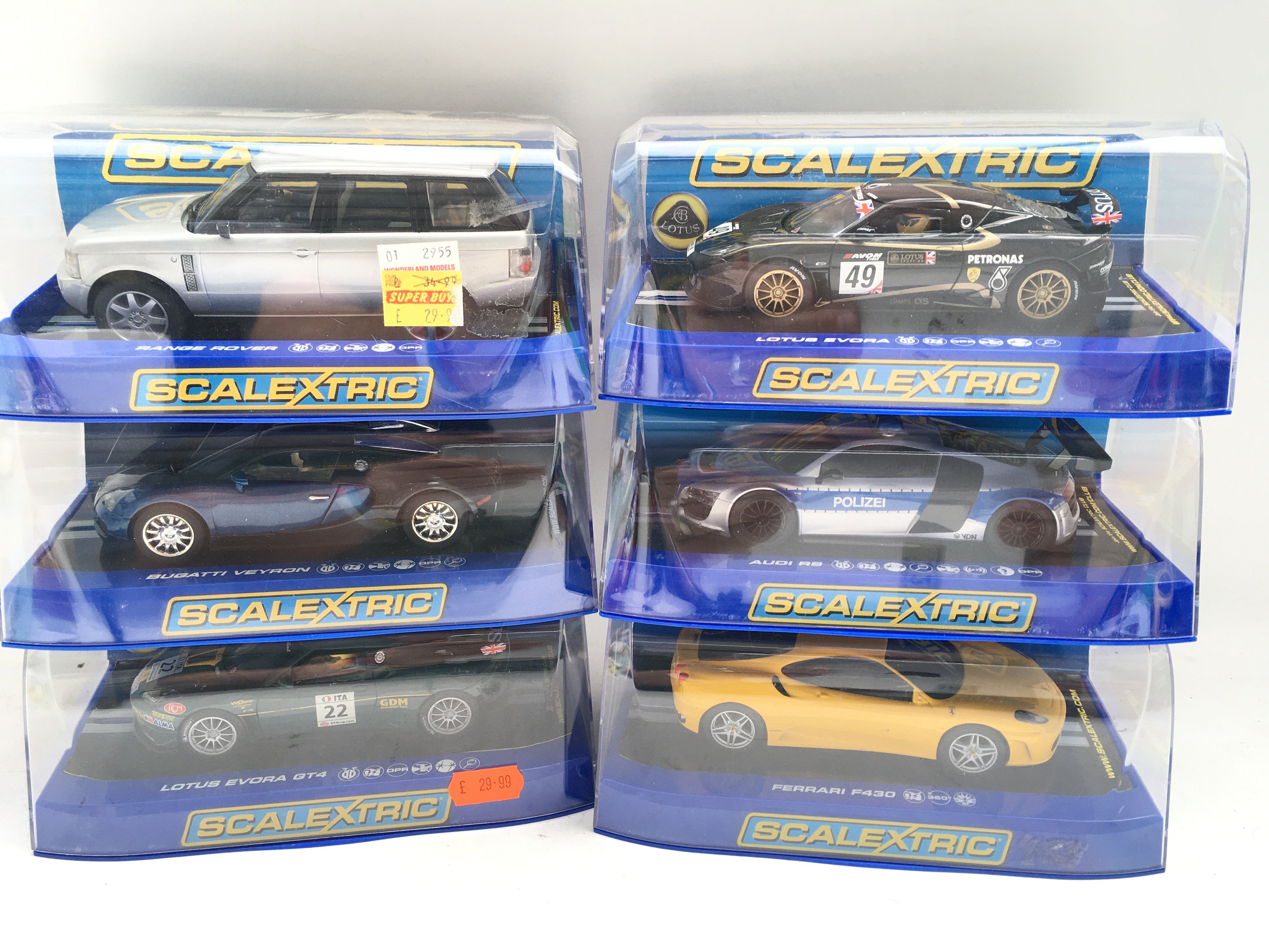 A Collection of 6 Boxed Scalextric Cars. A Range Rover. A Bugatti Veyron. A Audi R8. A Ferrari F430. And 2 Lotus Evoras.