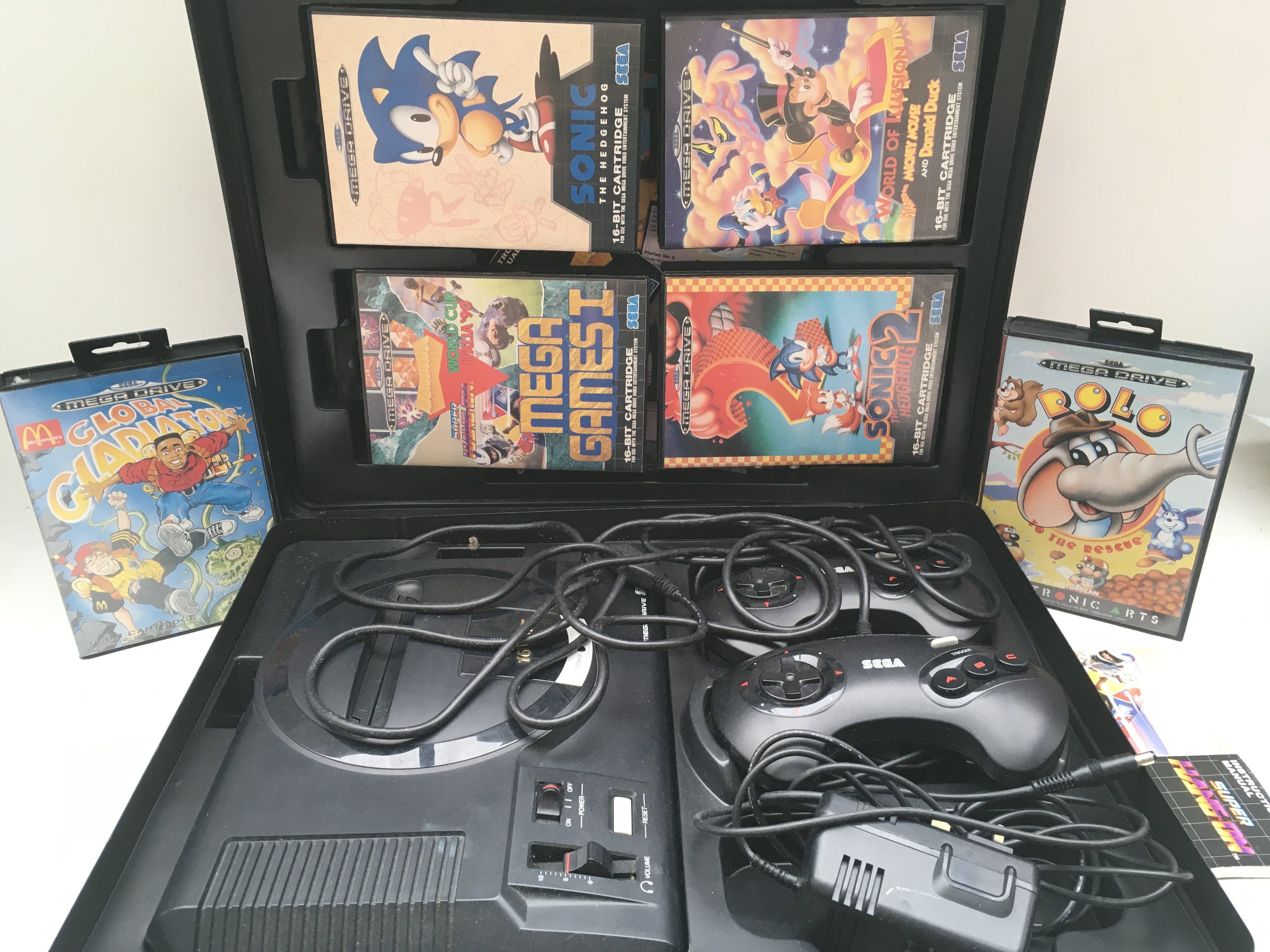 A Sega Mega Drive With Games in a Carry Case.