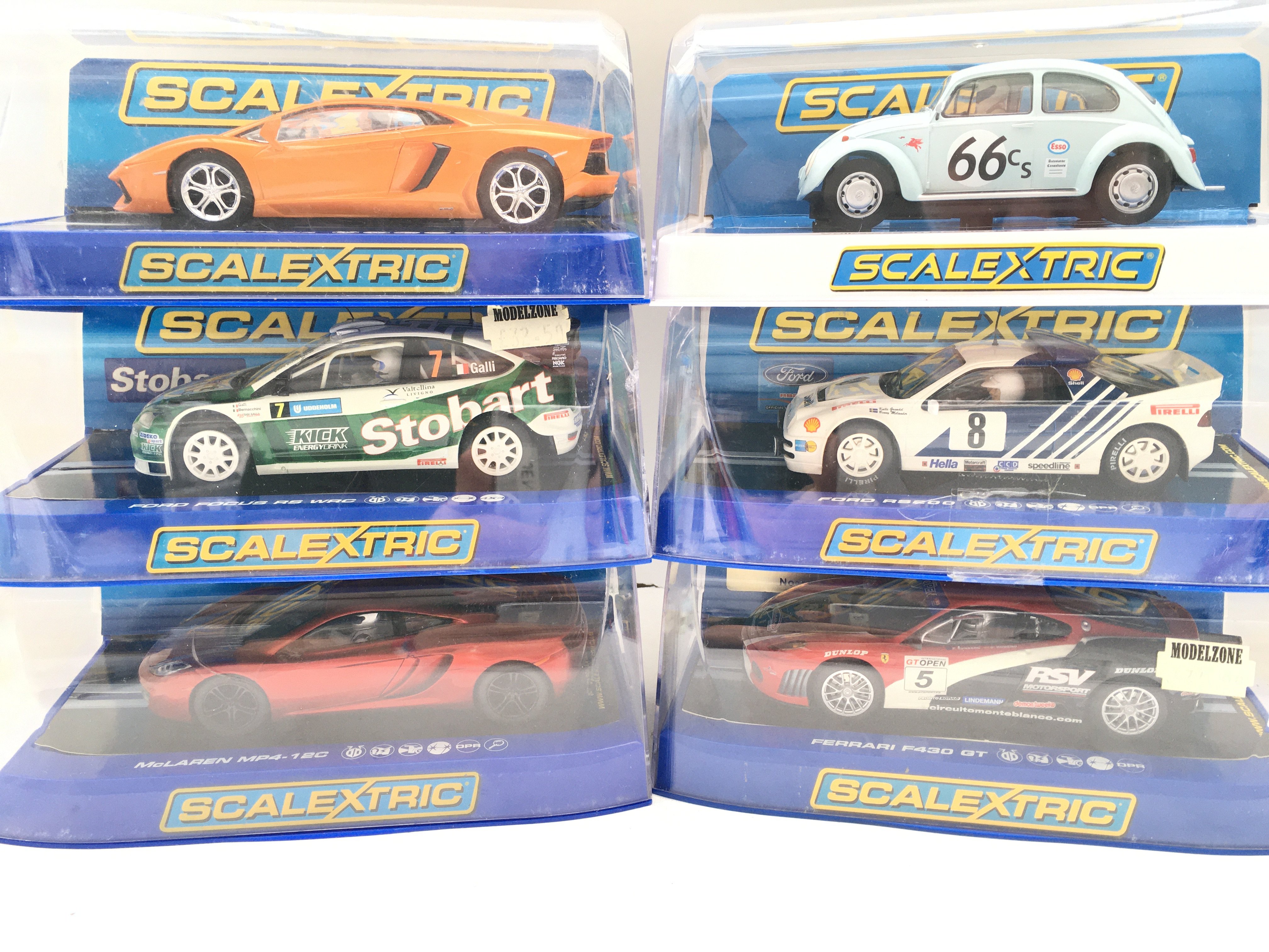 6 Boxed Scalextric Cars Including a Lamborghini. A Ford Focus. A McLaren MP4-12 C. A Volkswagen Beetle. A Ford R/S200 And A Ferrari F430 GT.