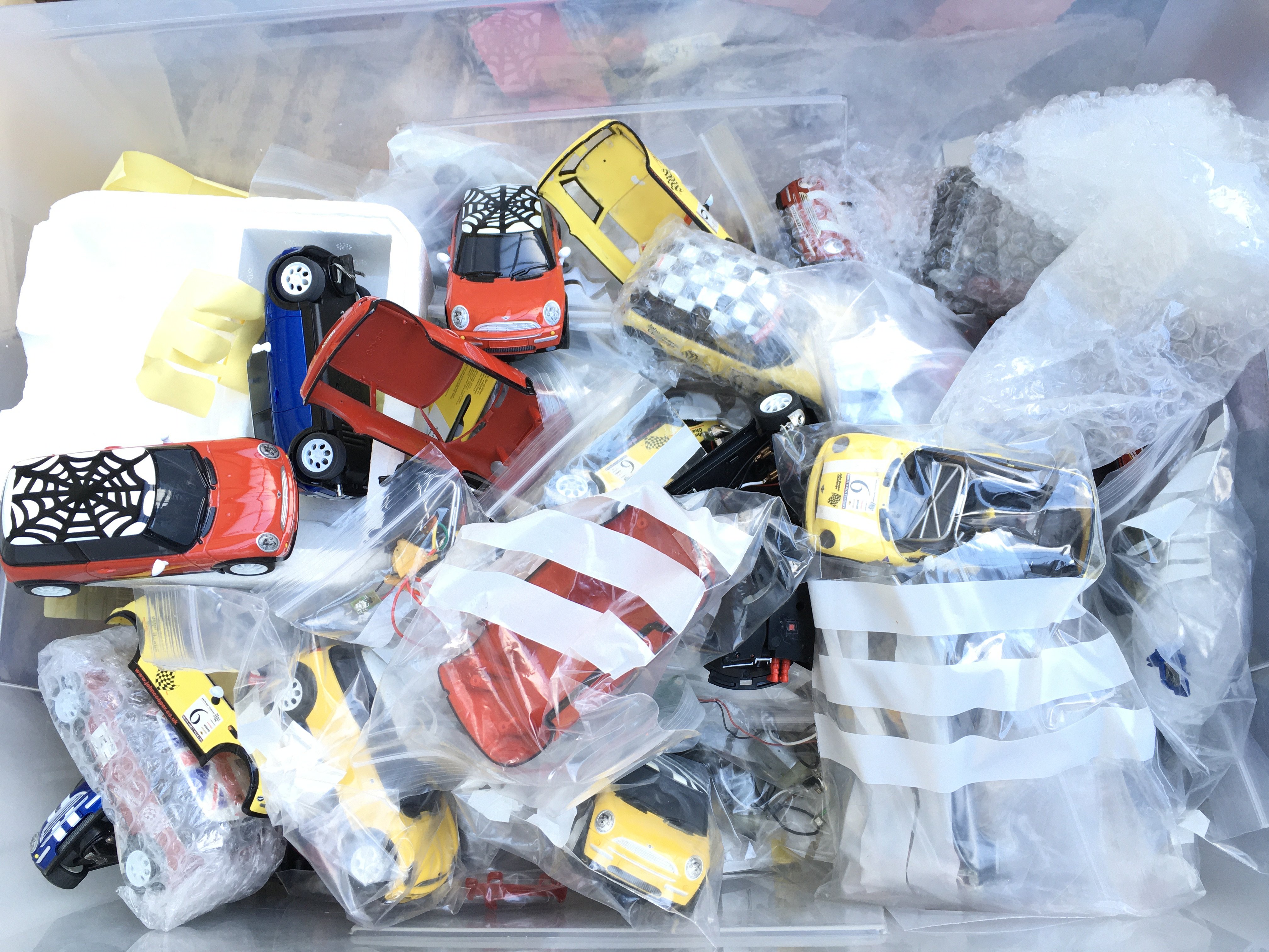 A Box Containing Scalextric Minis And Spares.