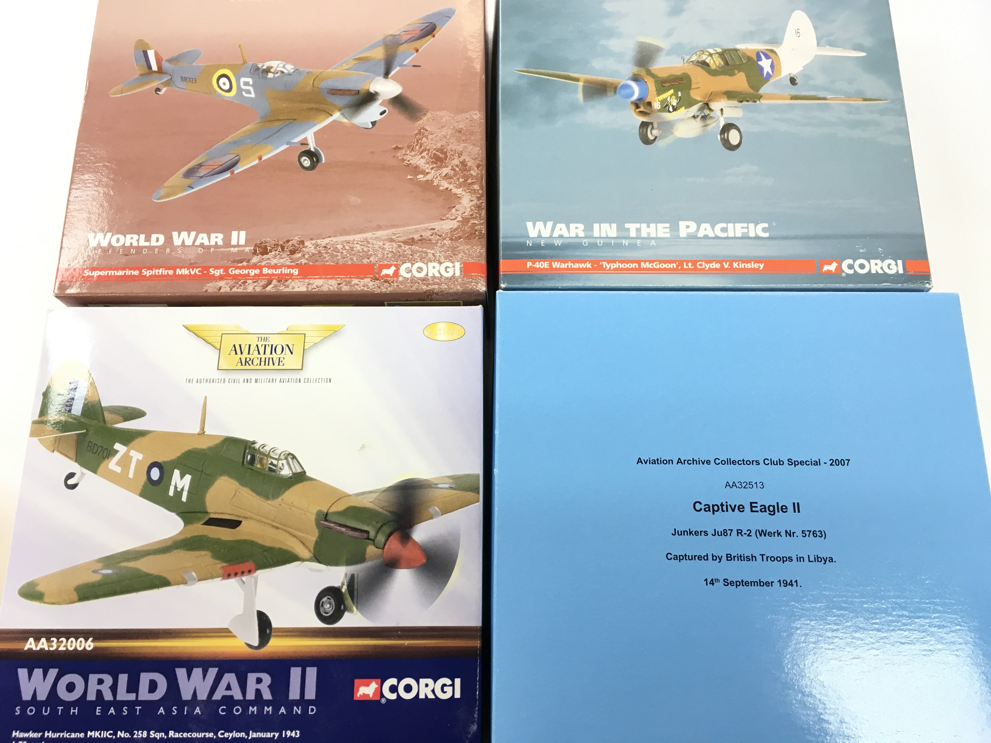 4 X Boxed Corgi Aviation Archive Diecast Aircraft. A Hawker Hurricane. A Captive Eagle II. A P-40E Warhawk and A Supermarine Spitfire. 1/72 Scale. No Reserve. (4).