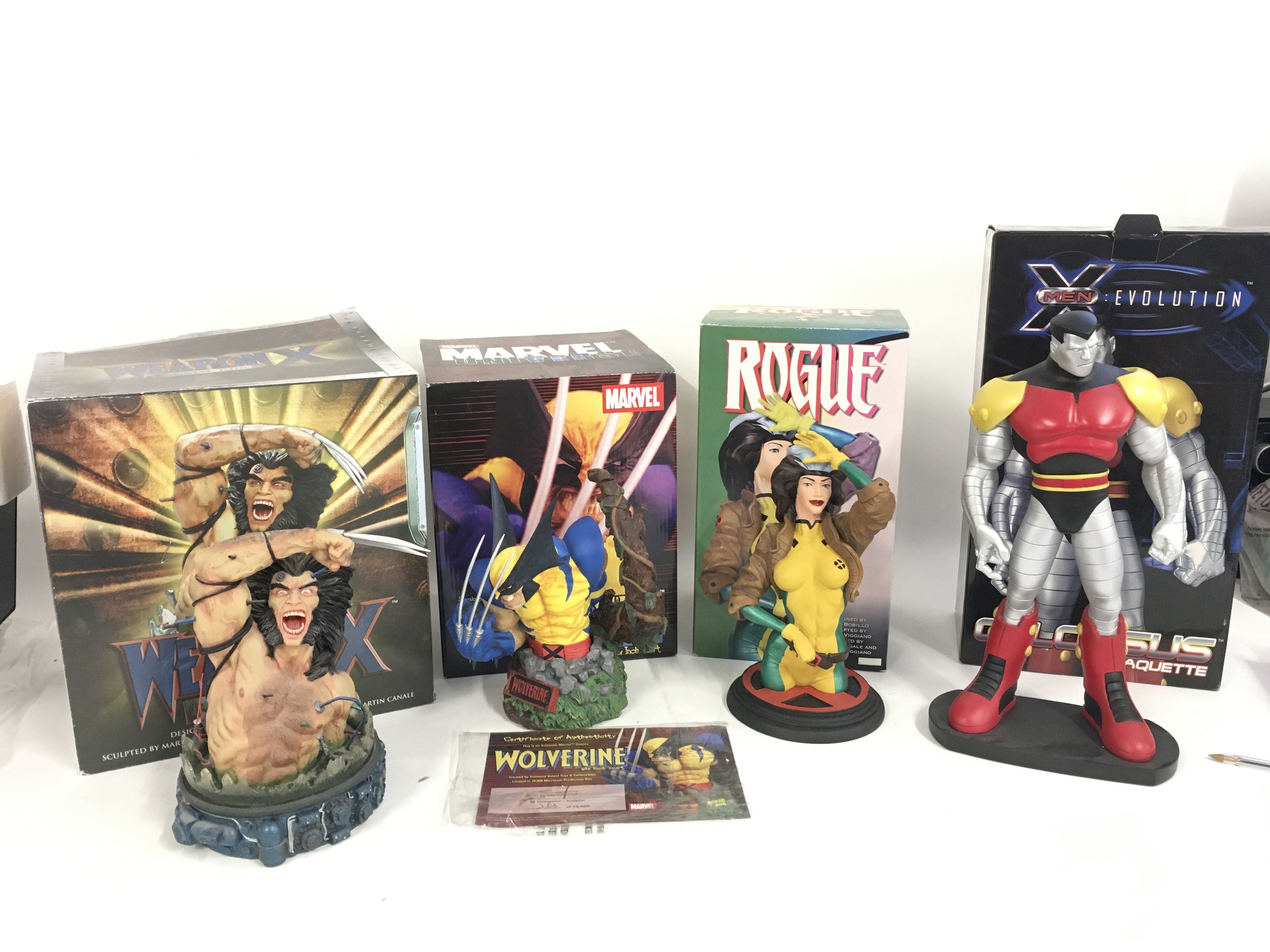 A collection of 4 boxed Marvel superhero models including a Wolverine 6&acirc; Bust by Eli Livingston a Rogue sculpture by Pablo Viggiano. WeaponX Bust sculpted by Martin Canale and Pablo Viggiano.. XMen Evolution Colossus statue sculpted by Seth Vandable. No reserve