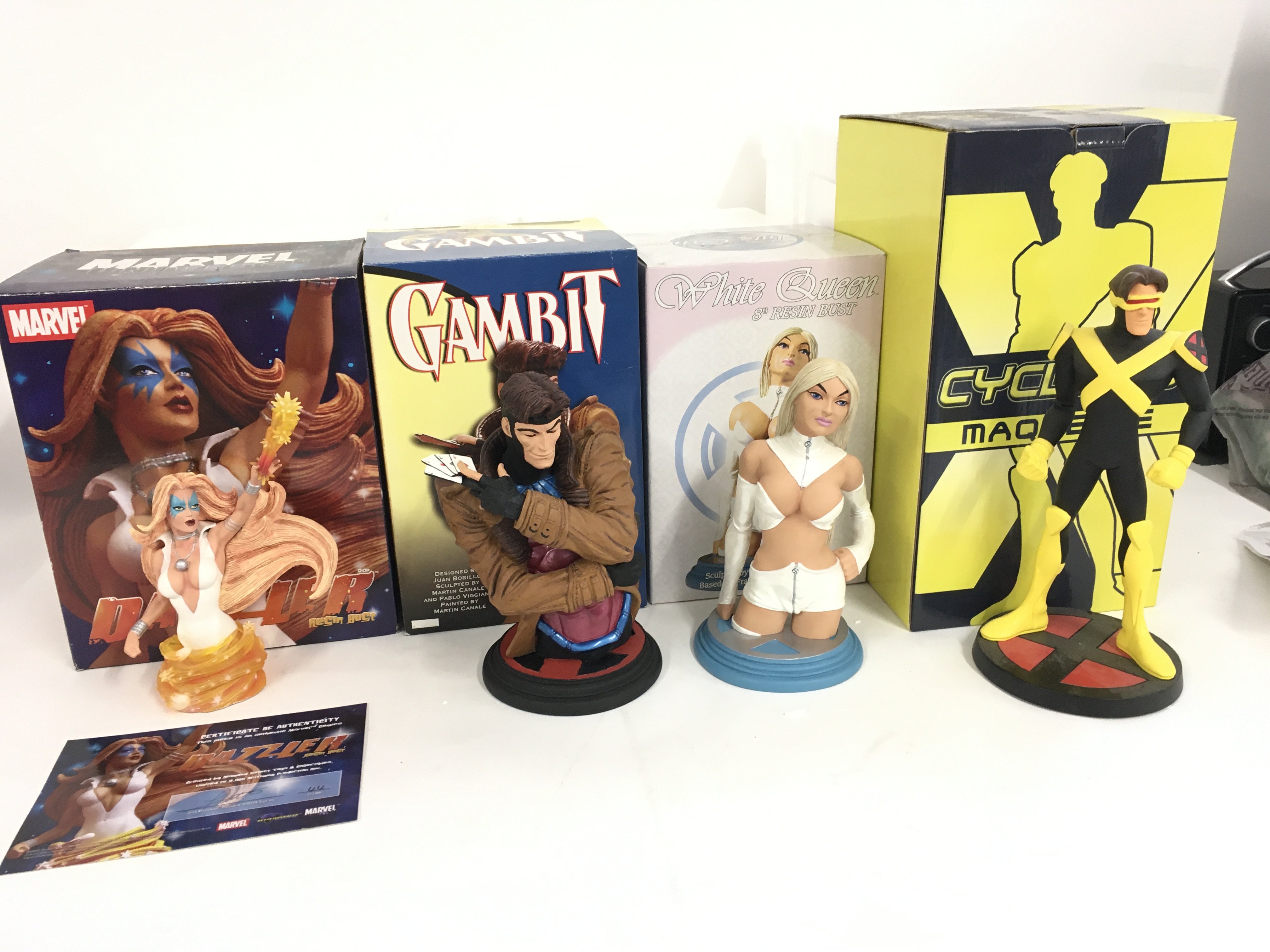 A collection of 4 Marvel sculptures including Dazzler..Gambit..White Queen and Cyclops. No reserve