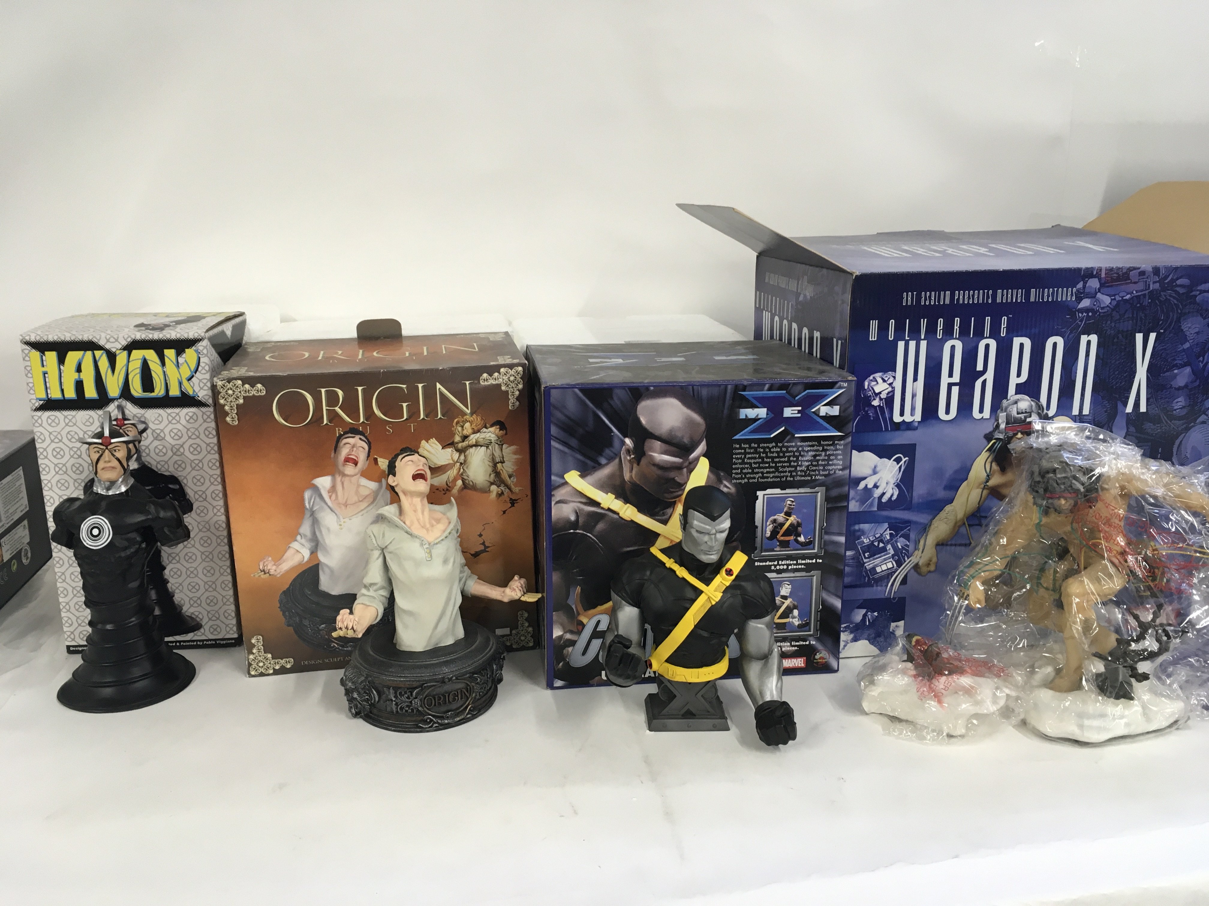 A collection of 4 boxed Marvel superhero sculptures including. Havok..Origin Rust..XMen Colossus..Wolverine WeaponX. No reserve