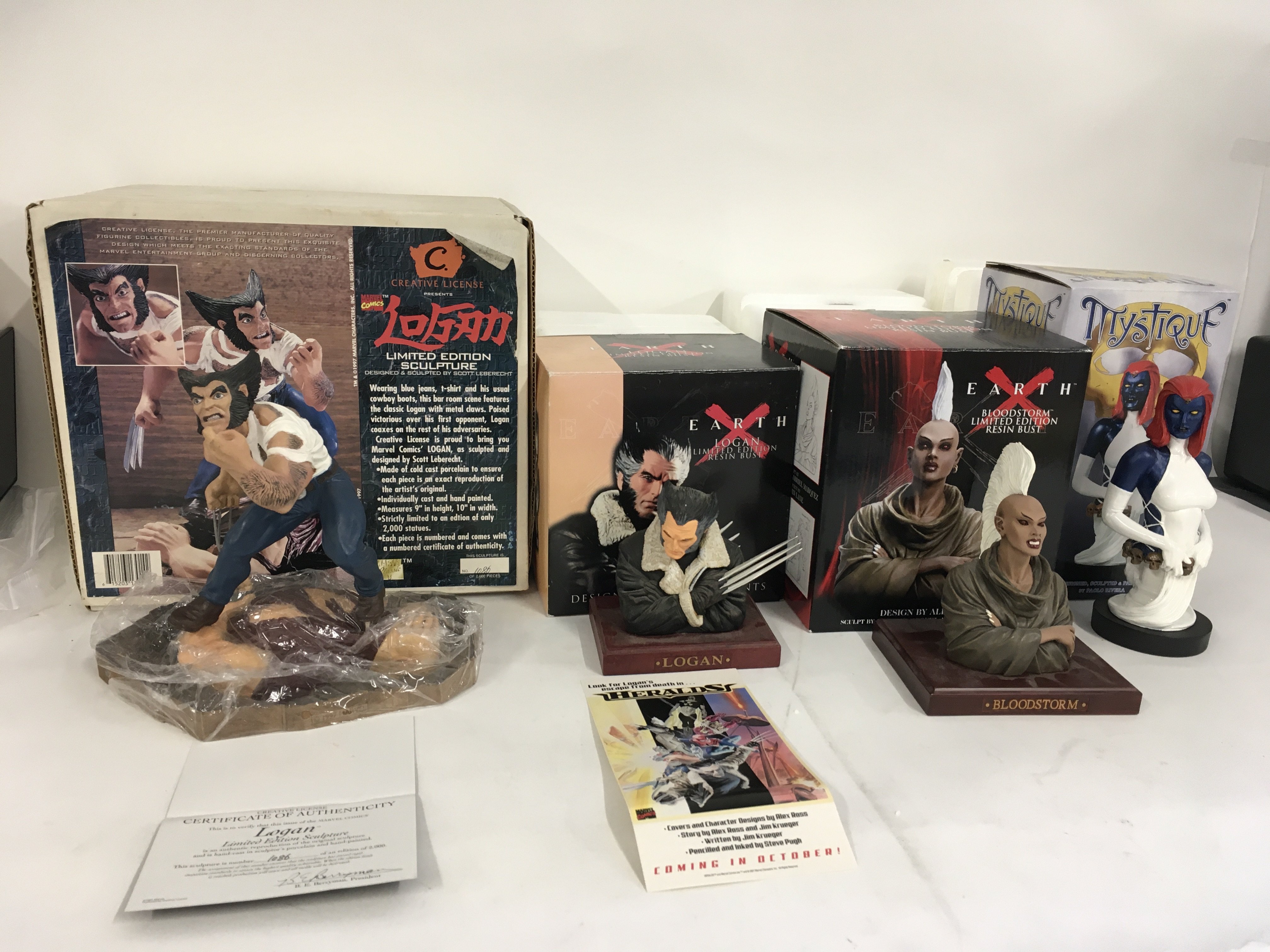 A collection of 4 Marvel superhero sculptures including..Logan x2.. Bloodstorm and Mystique. No reserve.