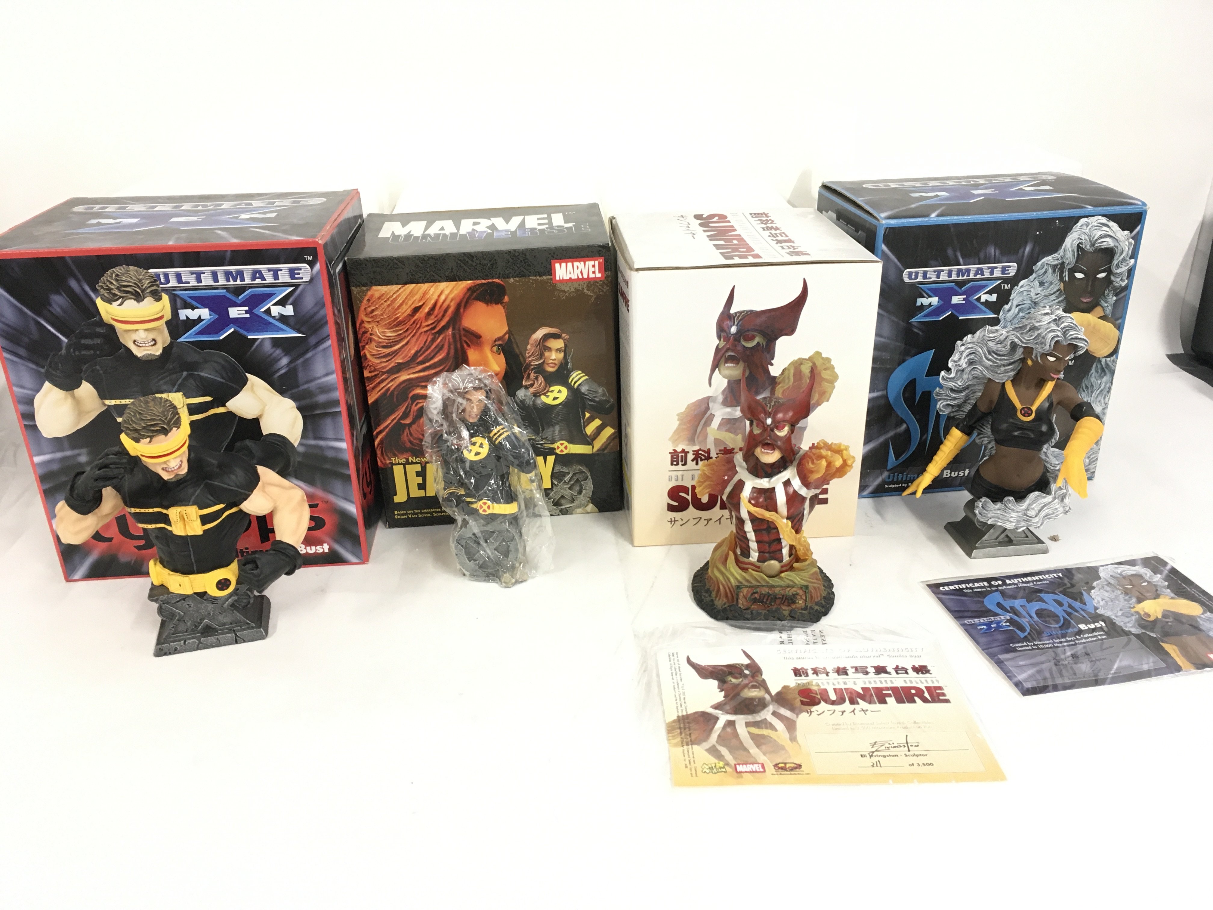 A collection of 4 boxed Marvel superhero sculptures featuring Cyclops..Jean Grey..Sunfire..Storm. No reserve