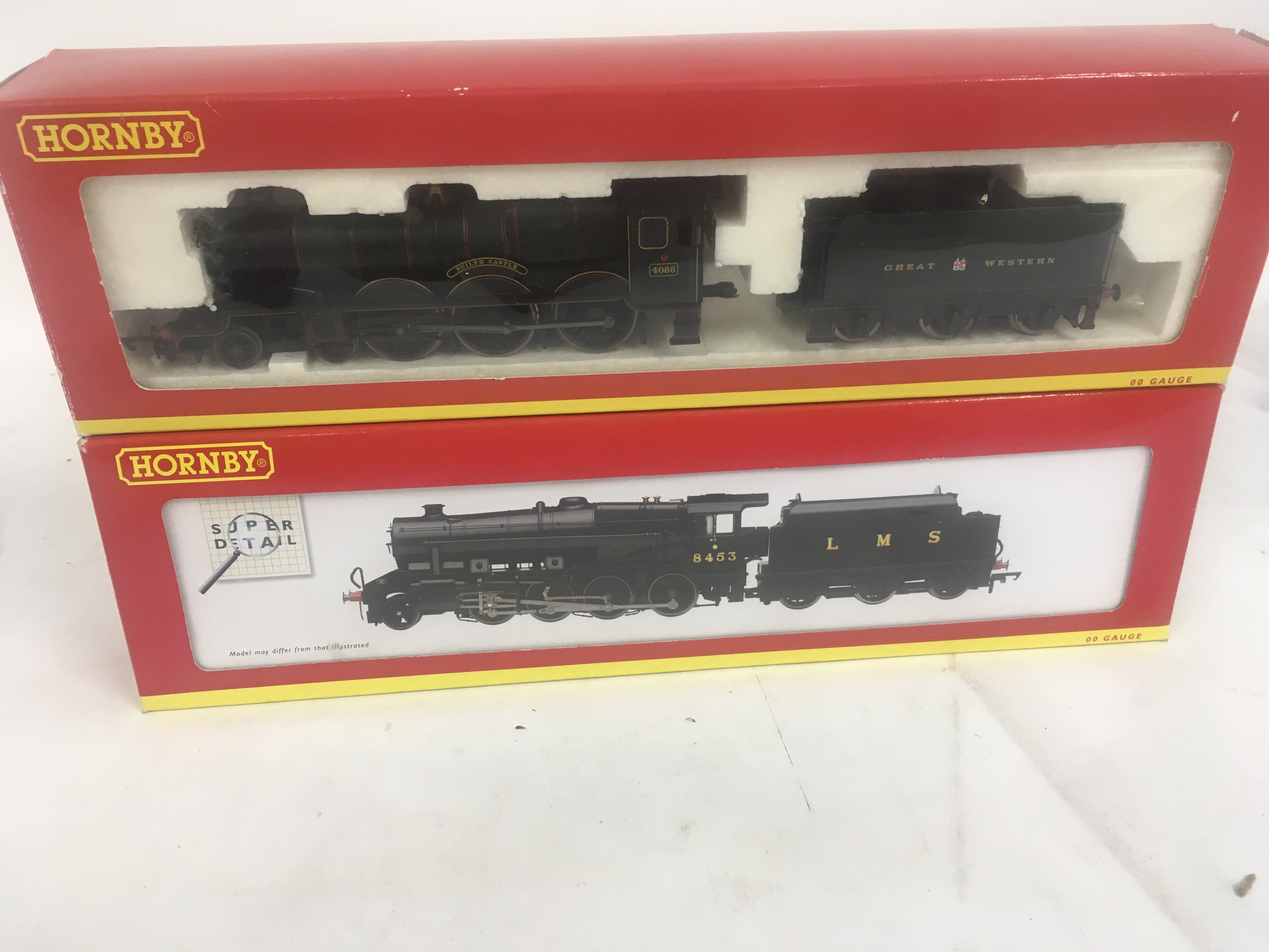 2 x boxed 00 gauge model railway locomotives by Hornby including R2389 Builth Castle and R2394 class 8F. No reserve