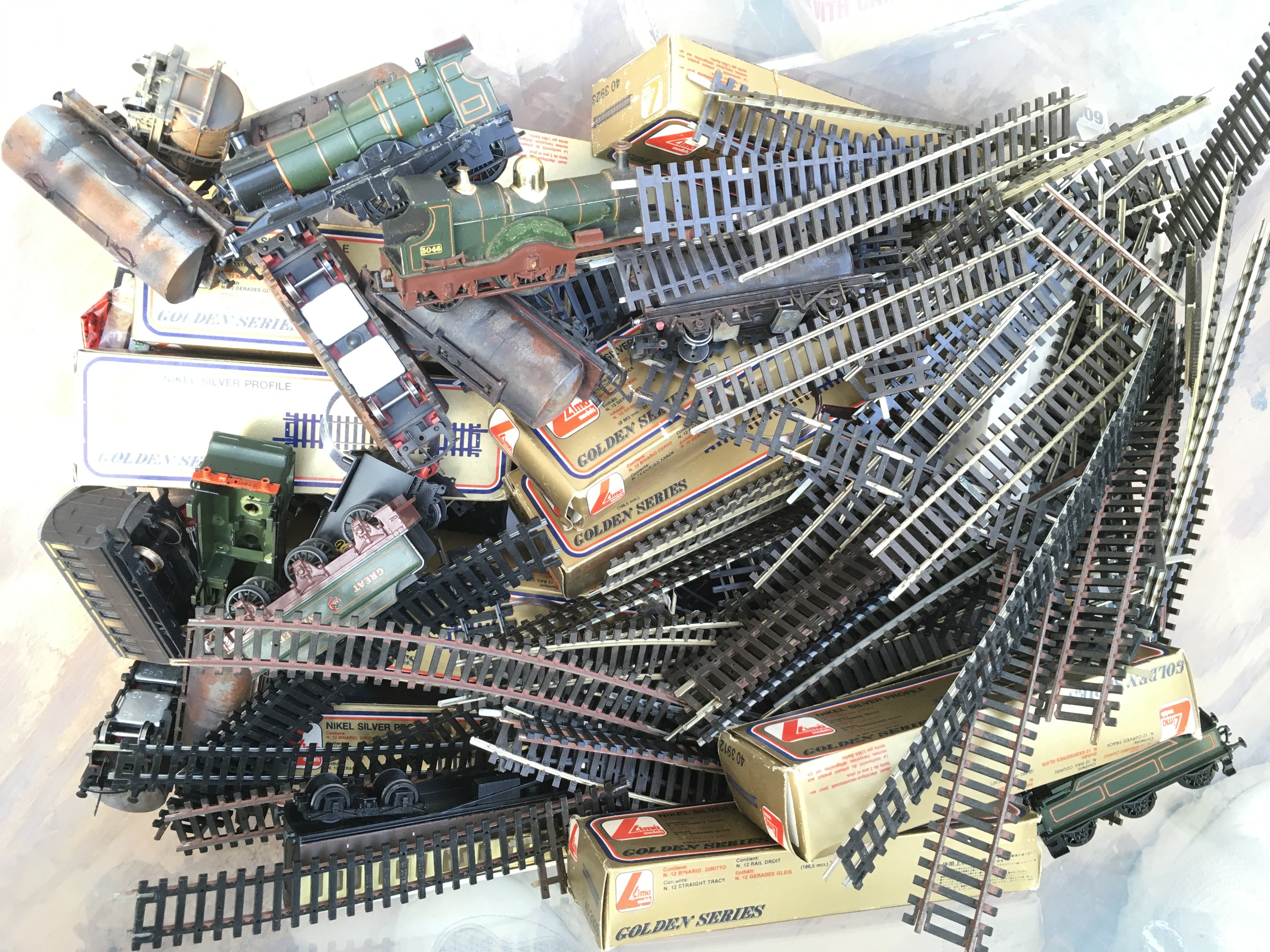 A Box Containing 00 Gauge Track. Spare parts. Model kits Etc. No Reserve.