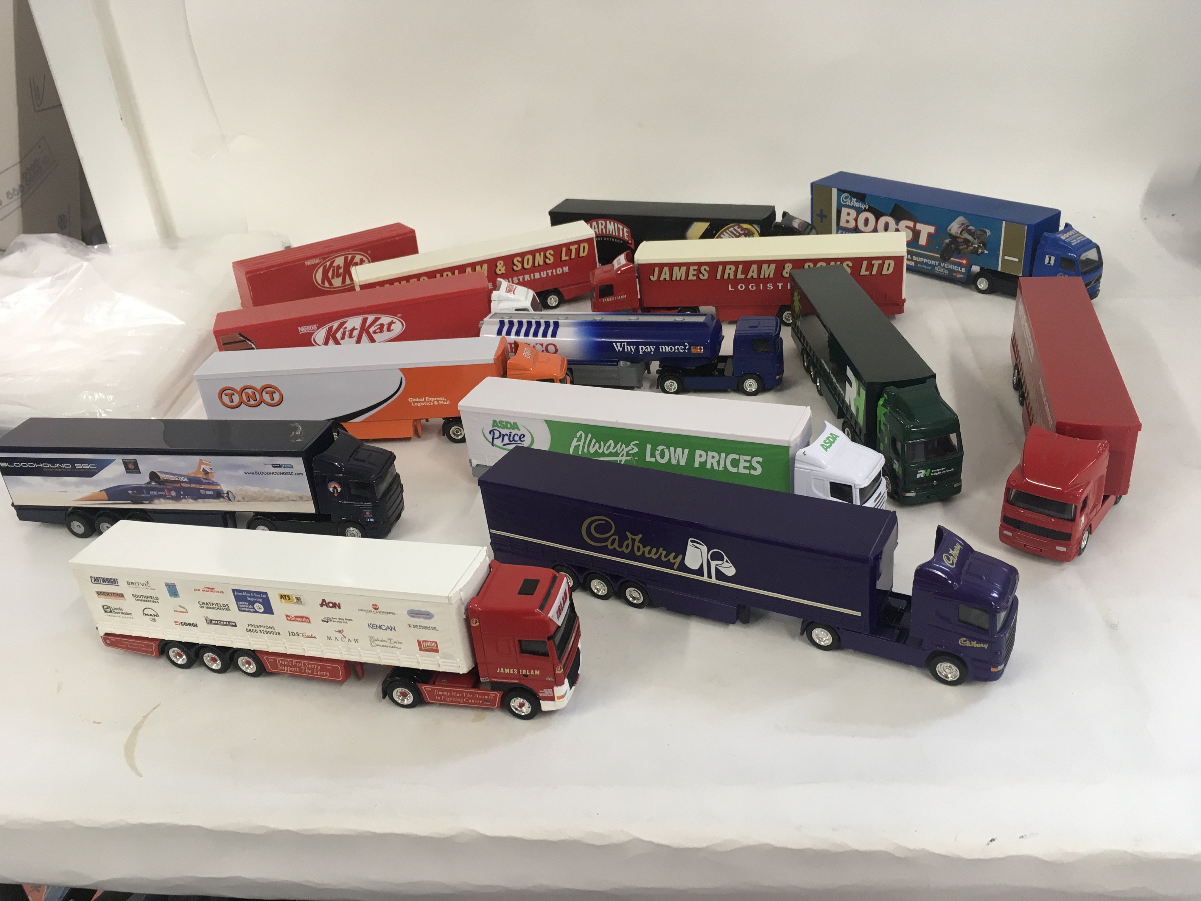 A collection of 12 unboxed model commercial vehicles with trailers. Mostly Corgi. No reserve.