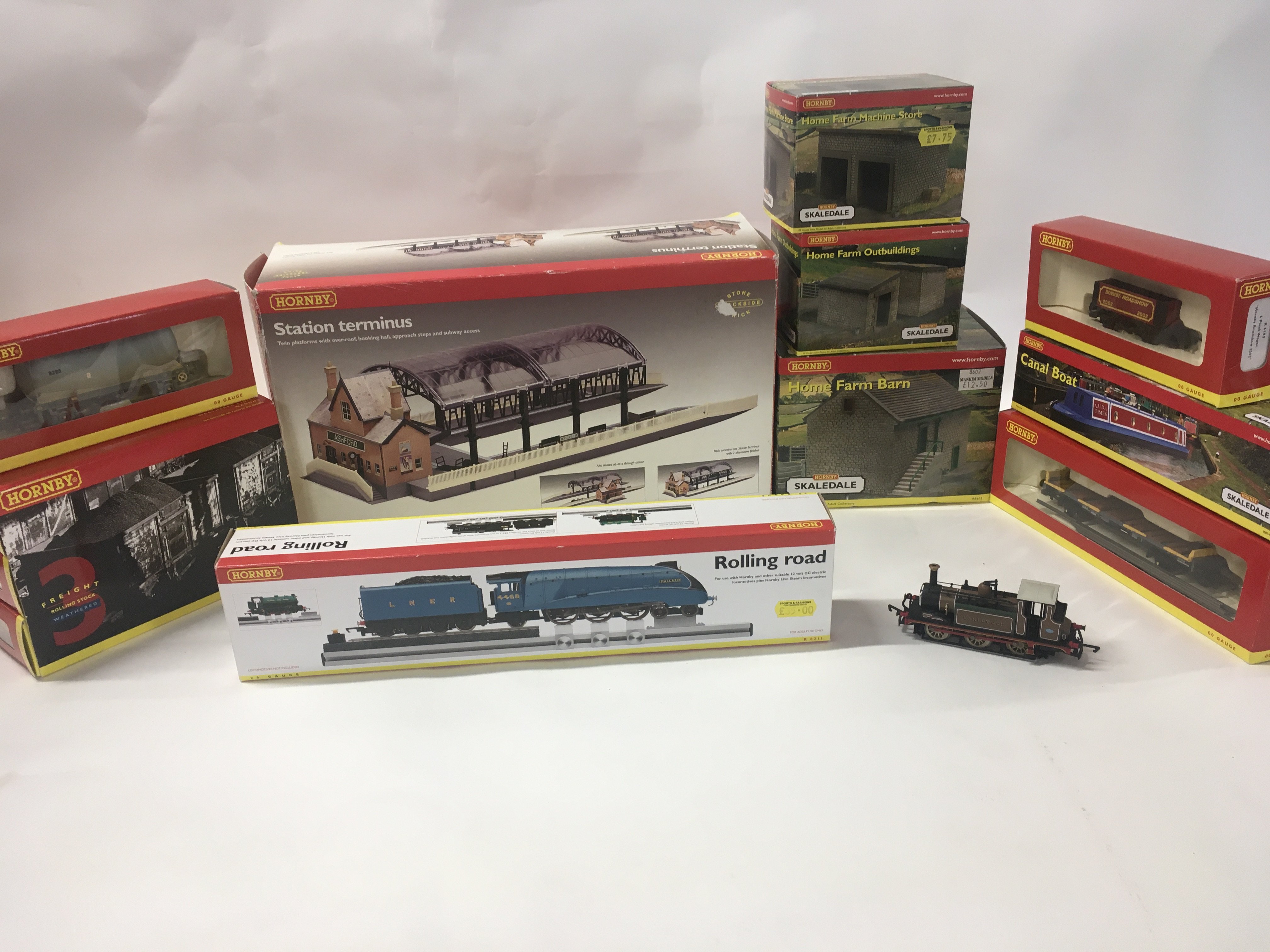 A collection of 00 gauge model railway items by Hornby including locomotives..wagons..buildings and a canal boat. R8211 R8746. R6120. R8602. R8610. R8609. R6153. R8009. No reserve