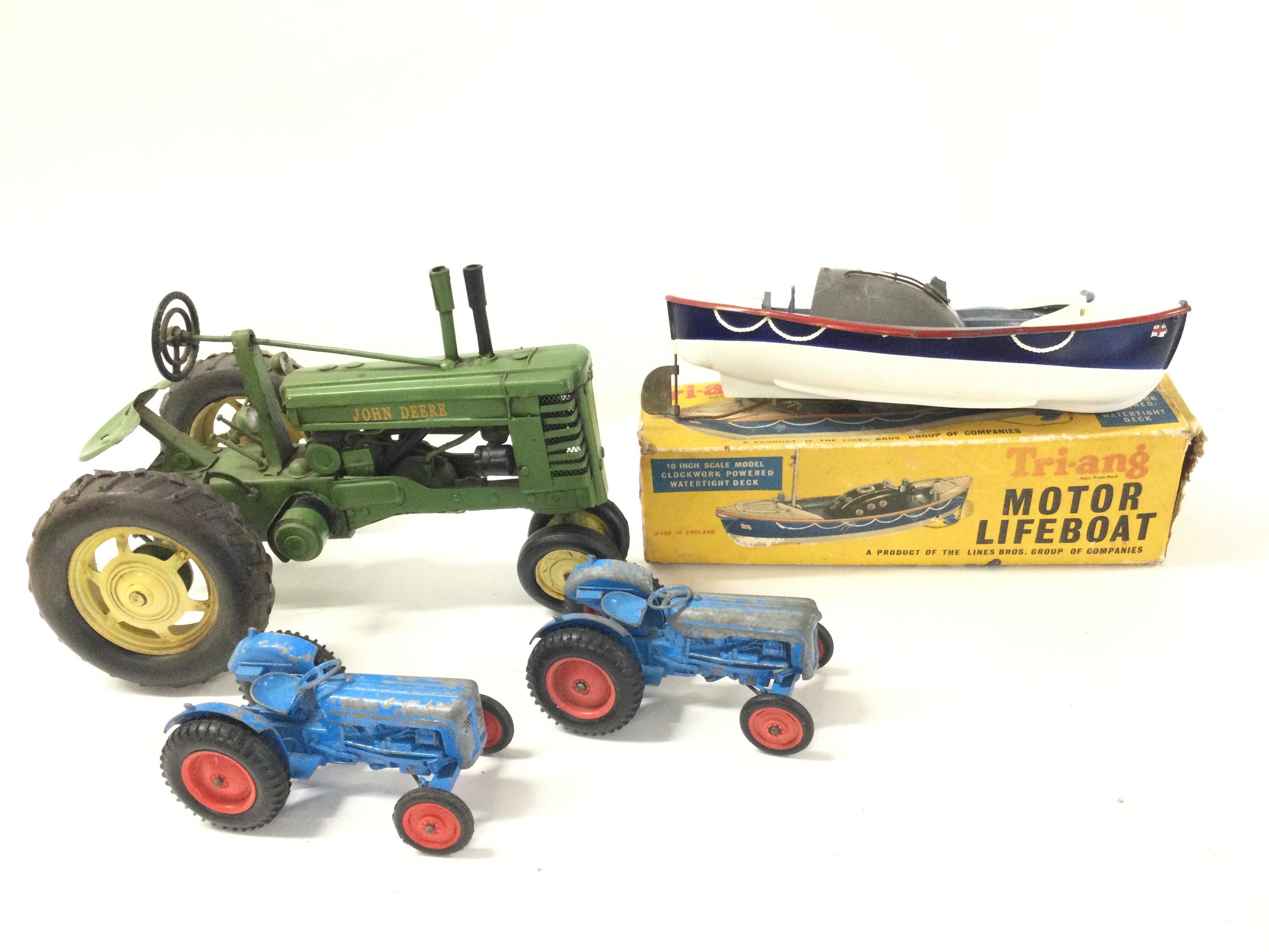 3 X Model Tractors And A Boxed Tri-Ang Lifeboat ( Parts Missing) No Reserve.