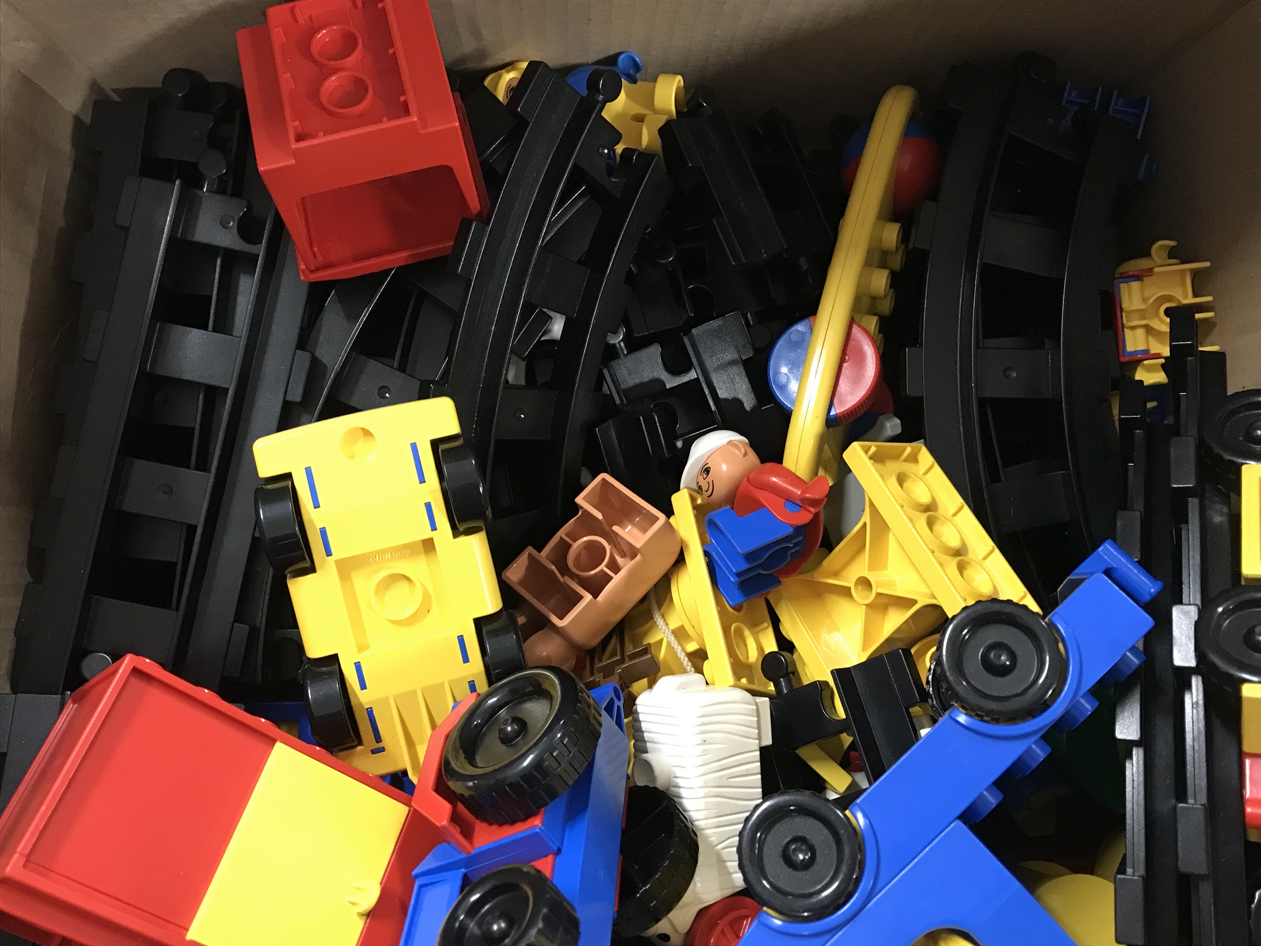 A box of assorted Duplo. Postage C