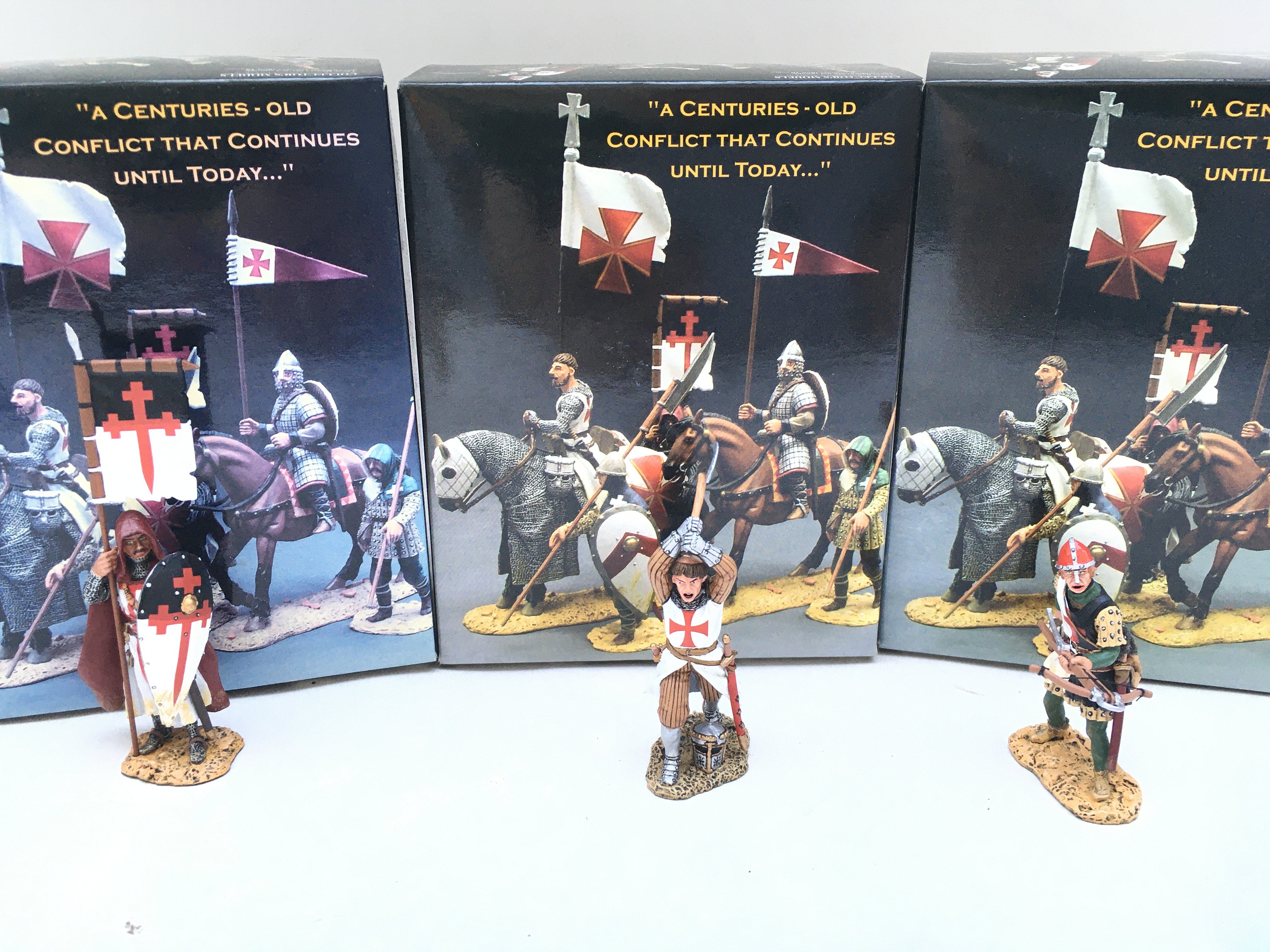 3 X Boxed King And Country Crusaders. A Crossbowman Loading. A Charging Knight And Standing Knight With Flag And Shield.