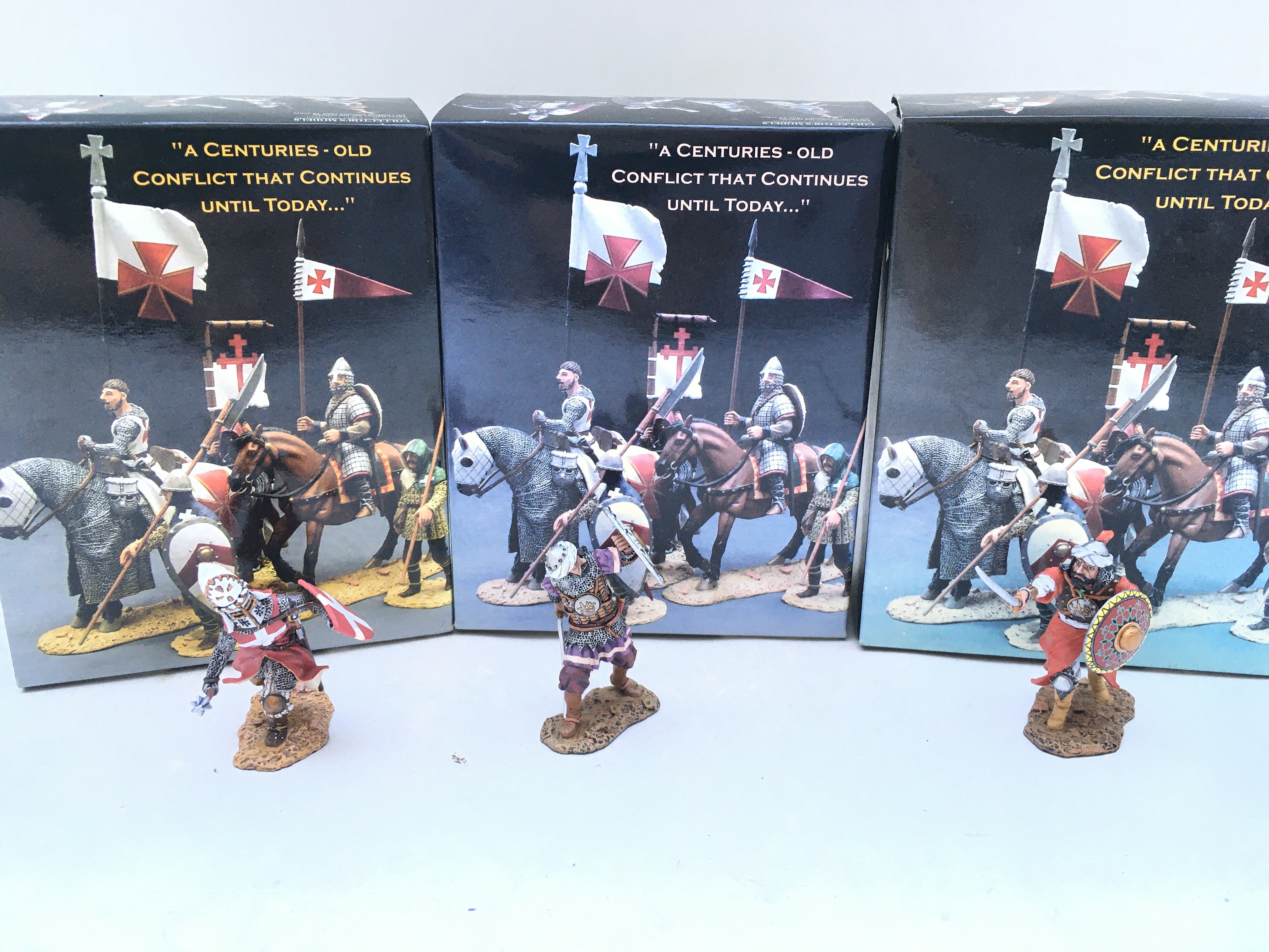 3 X Boxed King And Country Crusaders.A Fighting Bishop. A Saracen Defending With Sword And Shield And An Attacking Saracen With Sword And Shield.