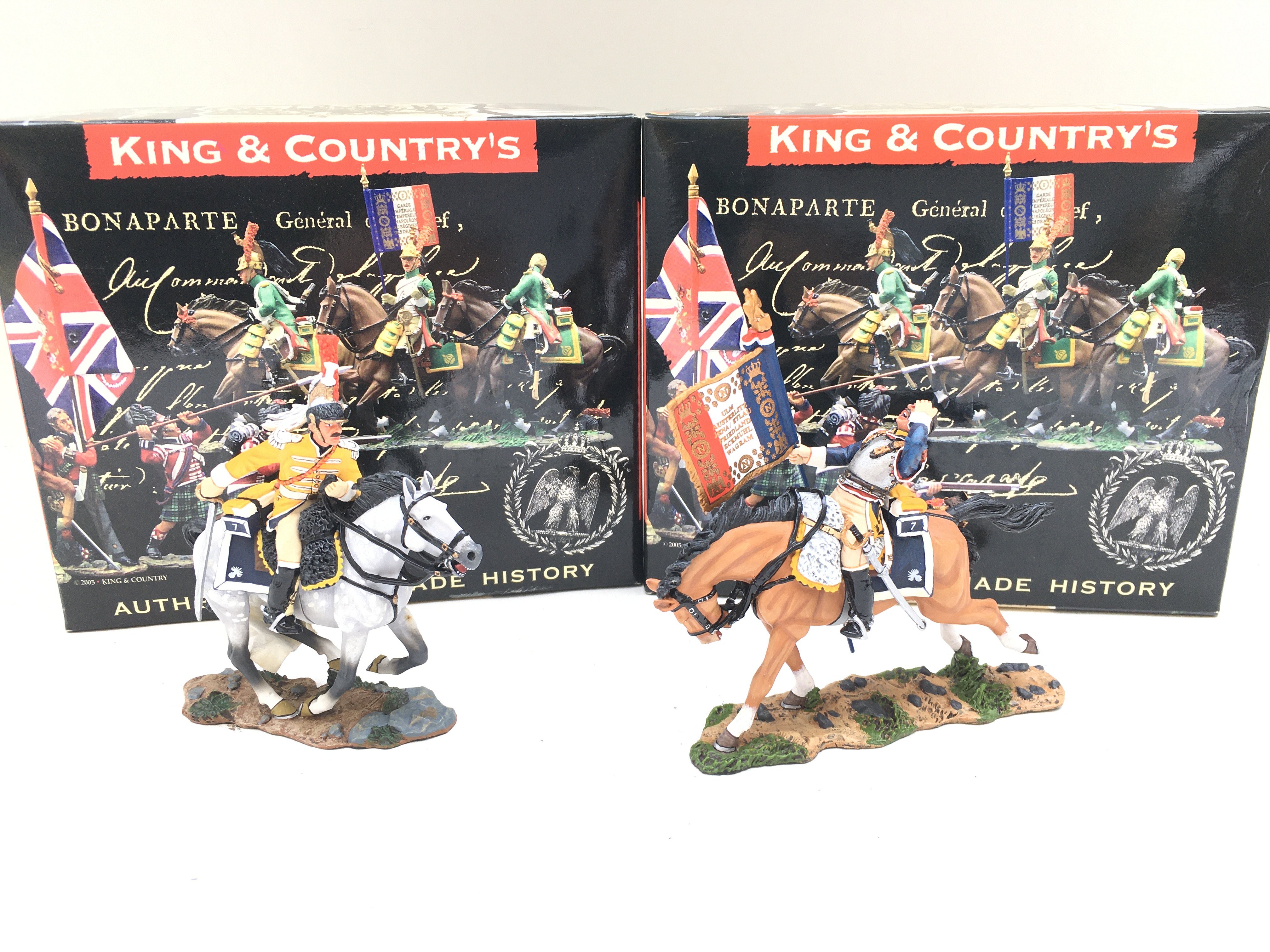 2 X Boxed King And Country Napoleonics Mounted Figures. A Wounded Flag-bearer And A Charging Trumpeter.