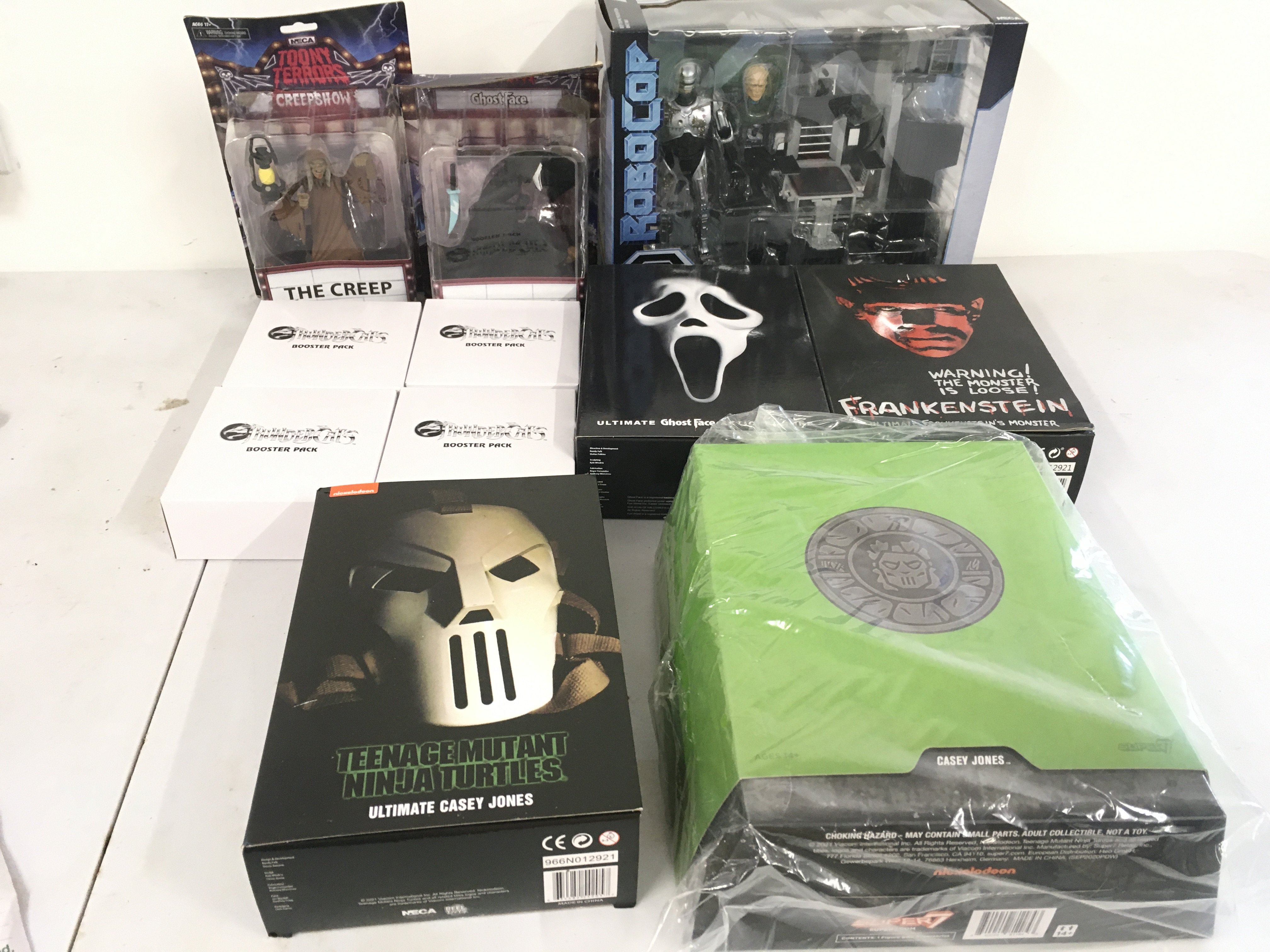 A collection of Neca and Super 7 figures with accessories.