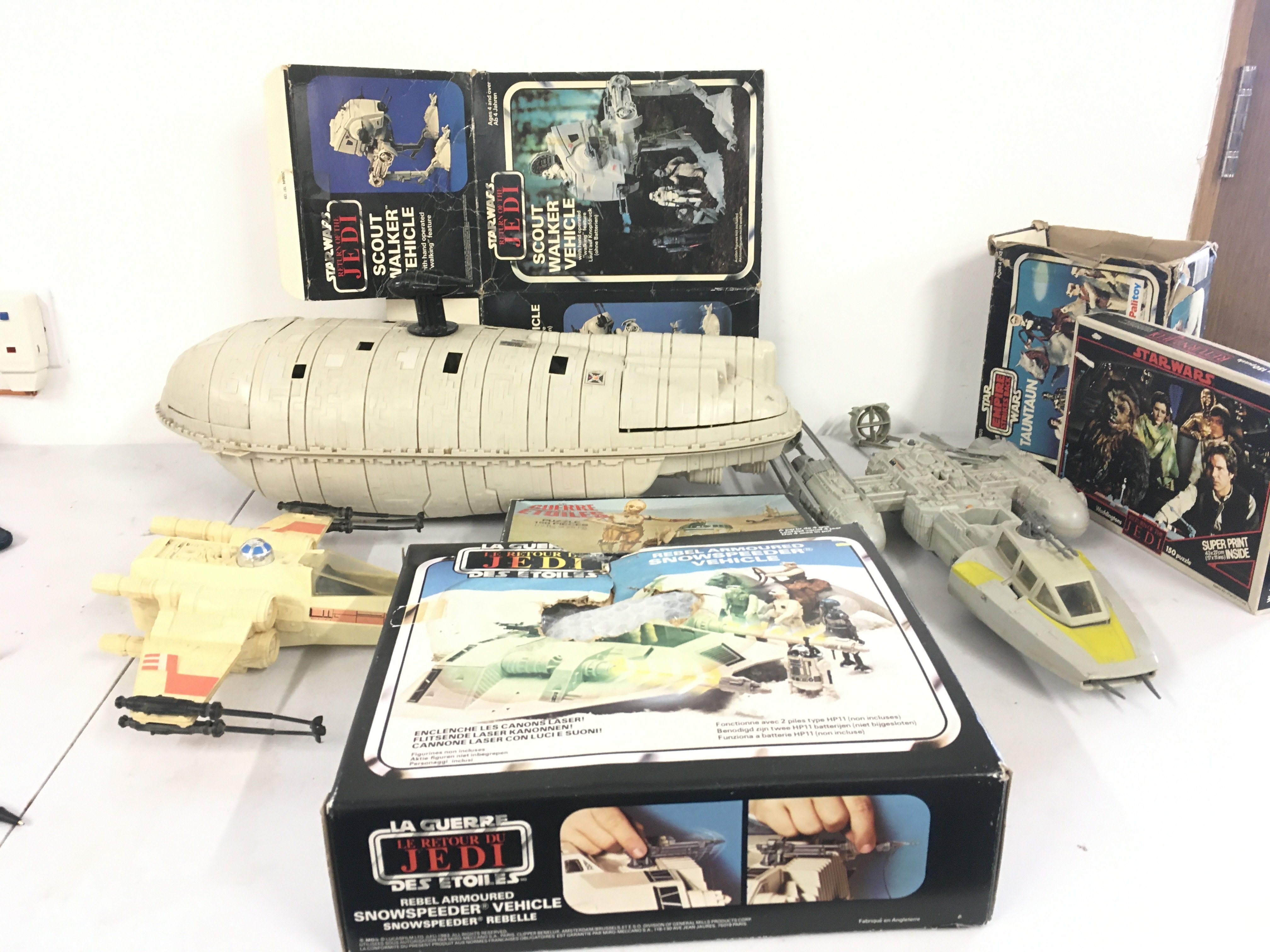 A collection of boxed and loose Vintage Star Wars items including a boxed Snowspeeder and Tauntaun.