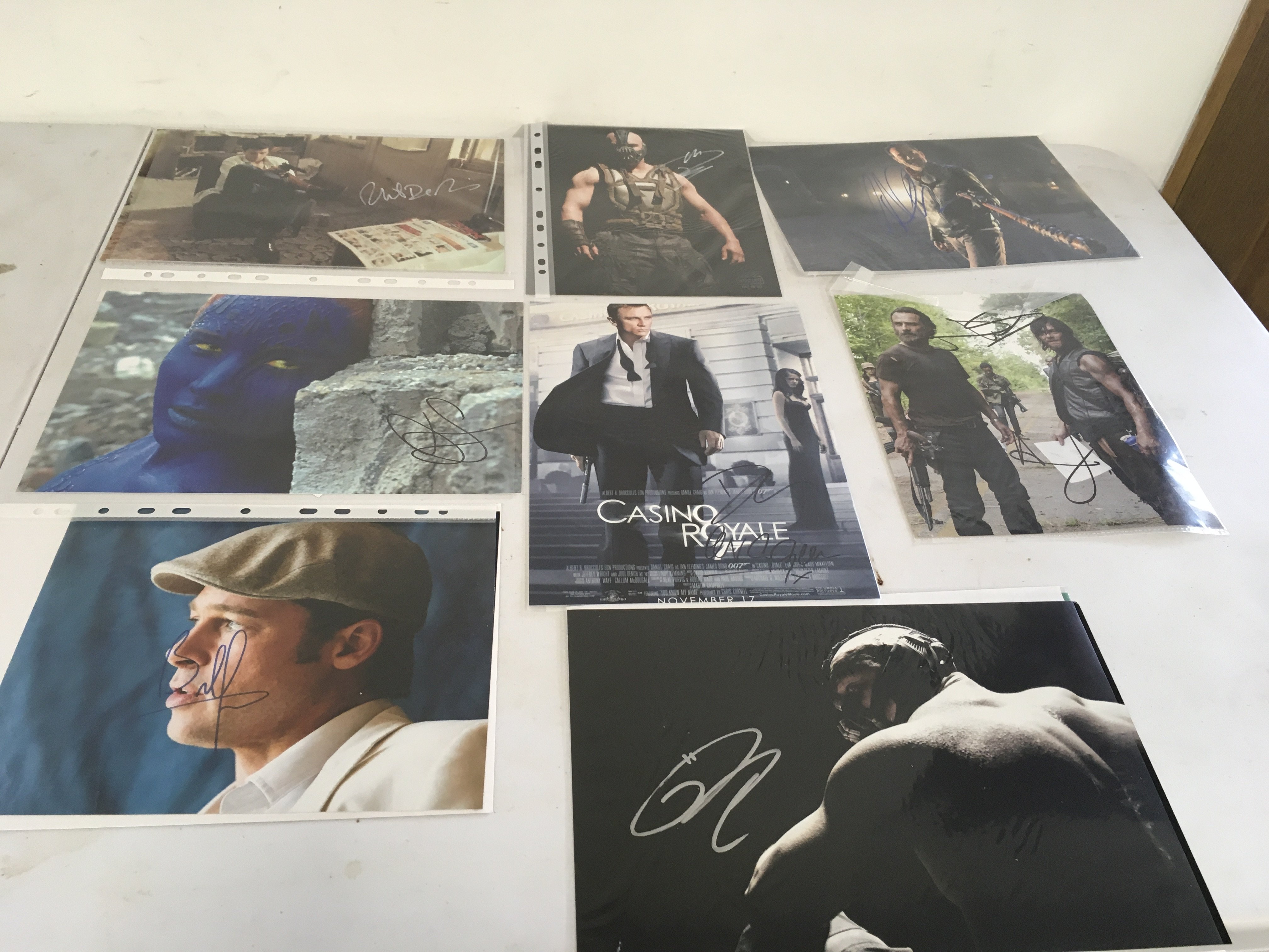 A collection of 8 signed TV and Film stars including Daniel Craig..Brad Pitt..Tom Hardy..Jennifer Lawrence Al Pacino and others.  Some with COA.
