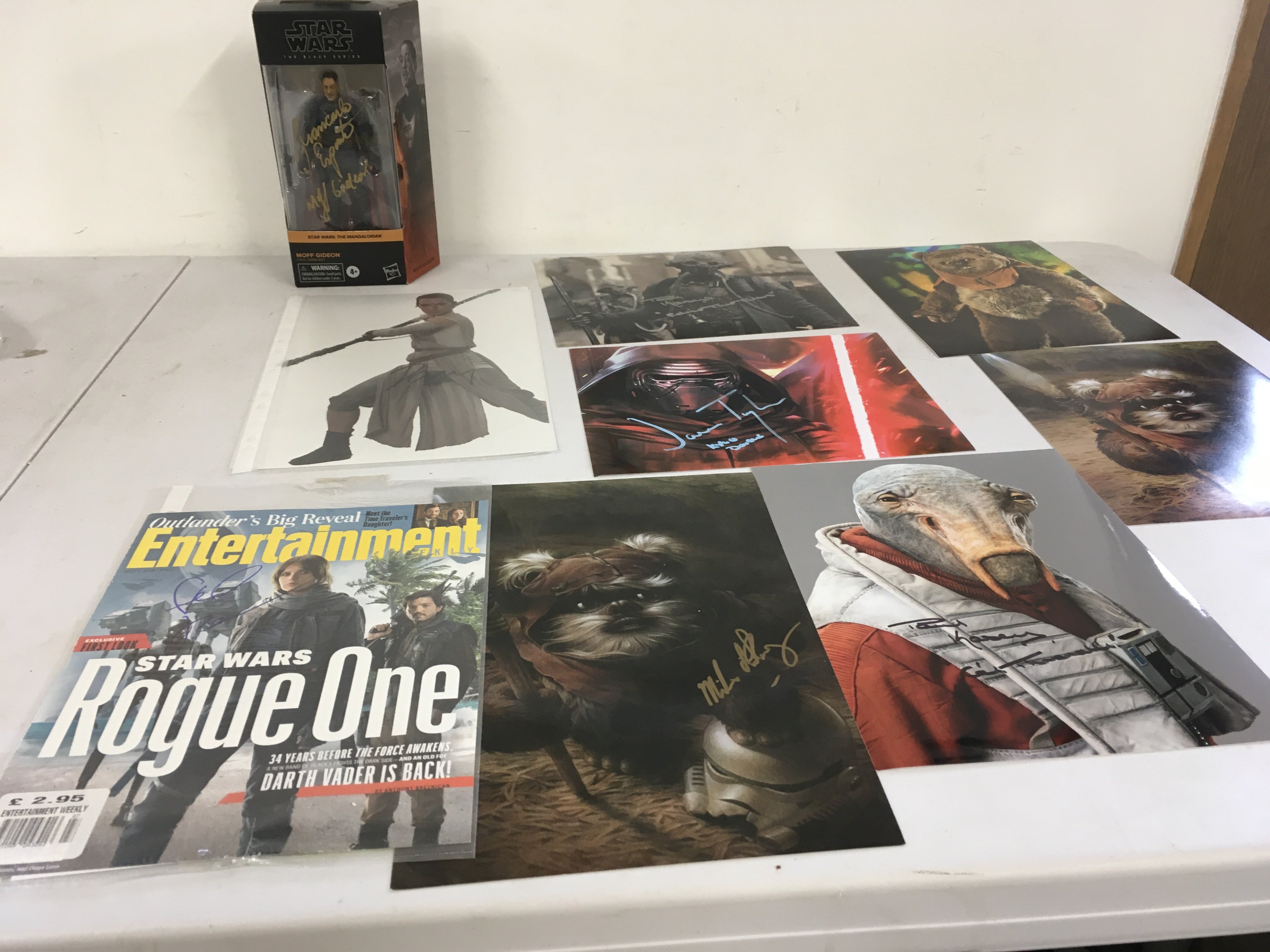 A collection of 9 Star Wars autographs including signed Giden boxed figure..Daisy Ridley..Felicity Jones..Paul Hasley plus others.  Some with COA.