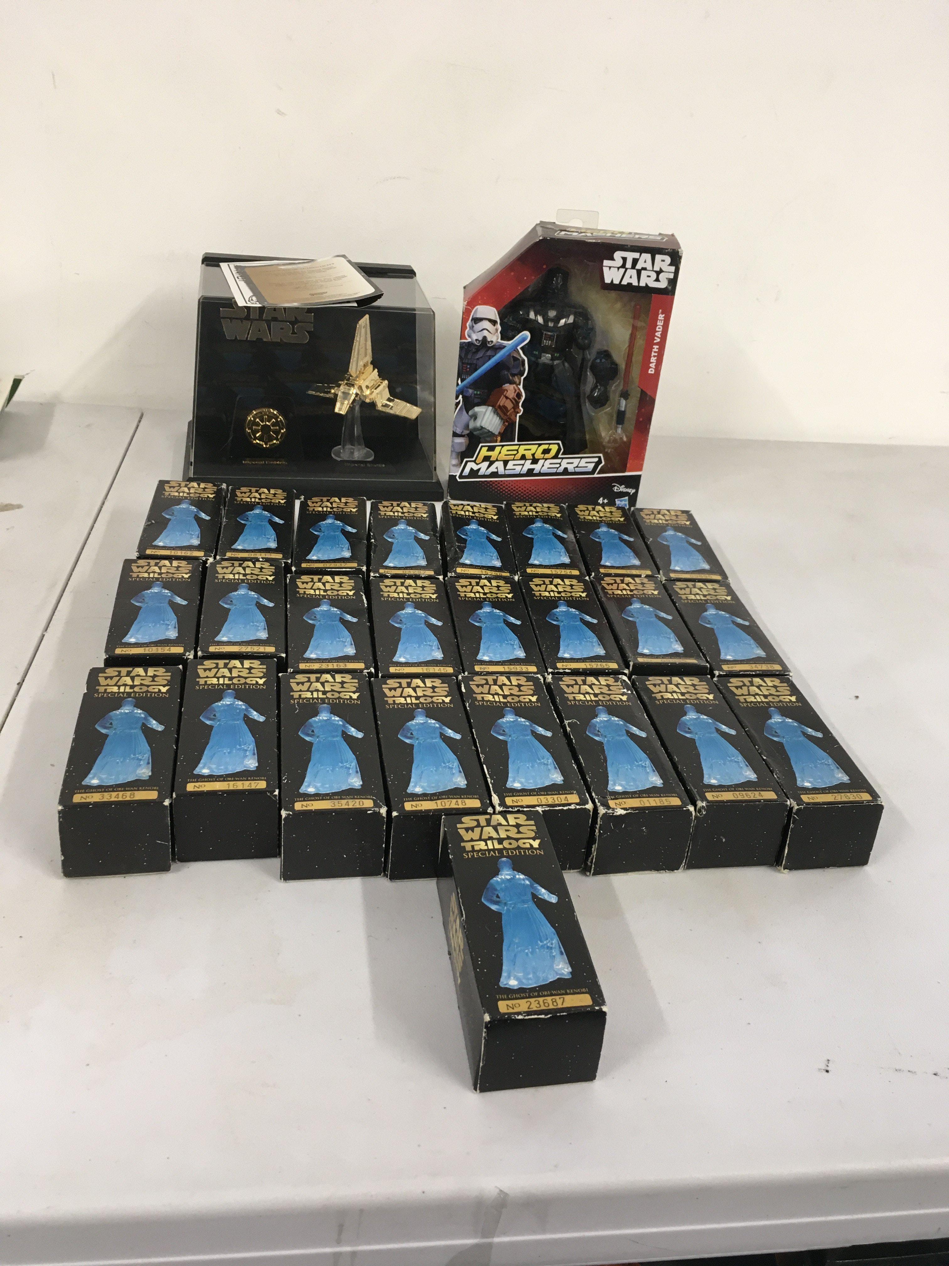 A collection of Star Wars models featuring 25 boxed numbered special edition Ghost of Obi Wan Kenobi.  Also includes display golden Imperial Shuttle and boxed Darth Vader.  No reserve