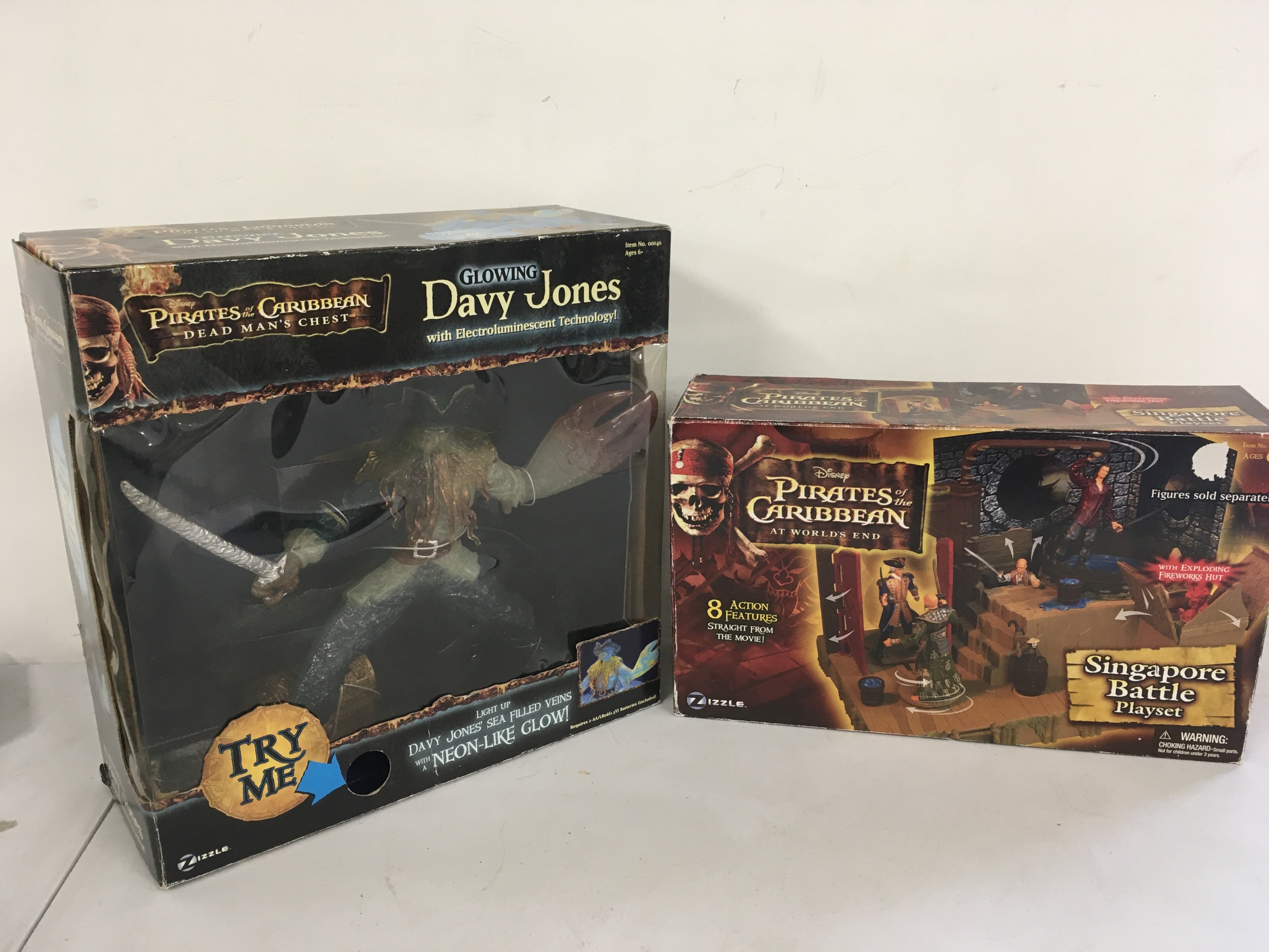 2 boxed Pirates of the Caribbean related items featuring Dead mans Chest glowing Davy Jones and T Worlds End Singapore Battle playset .  No reserve  (2)