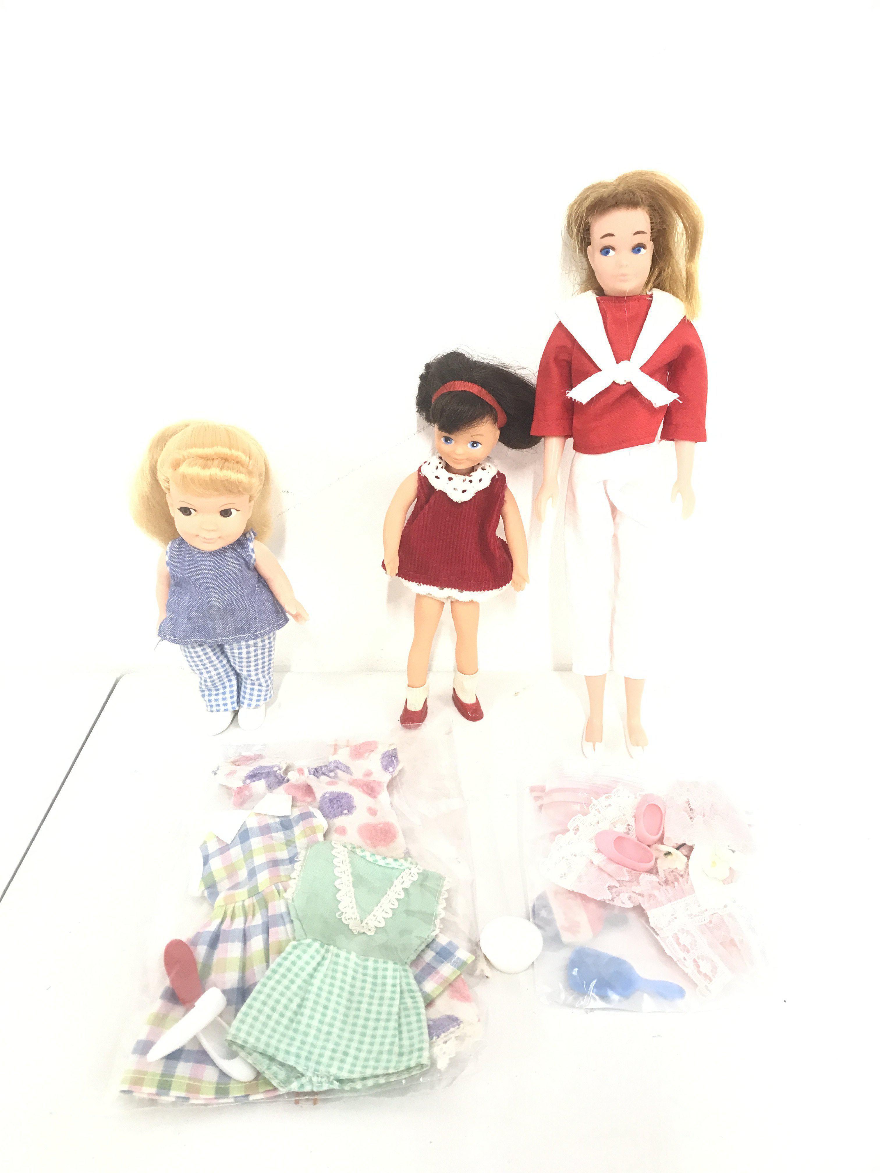 A Pedigree Betsy Doll And 2 Others. With Some clothes.