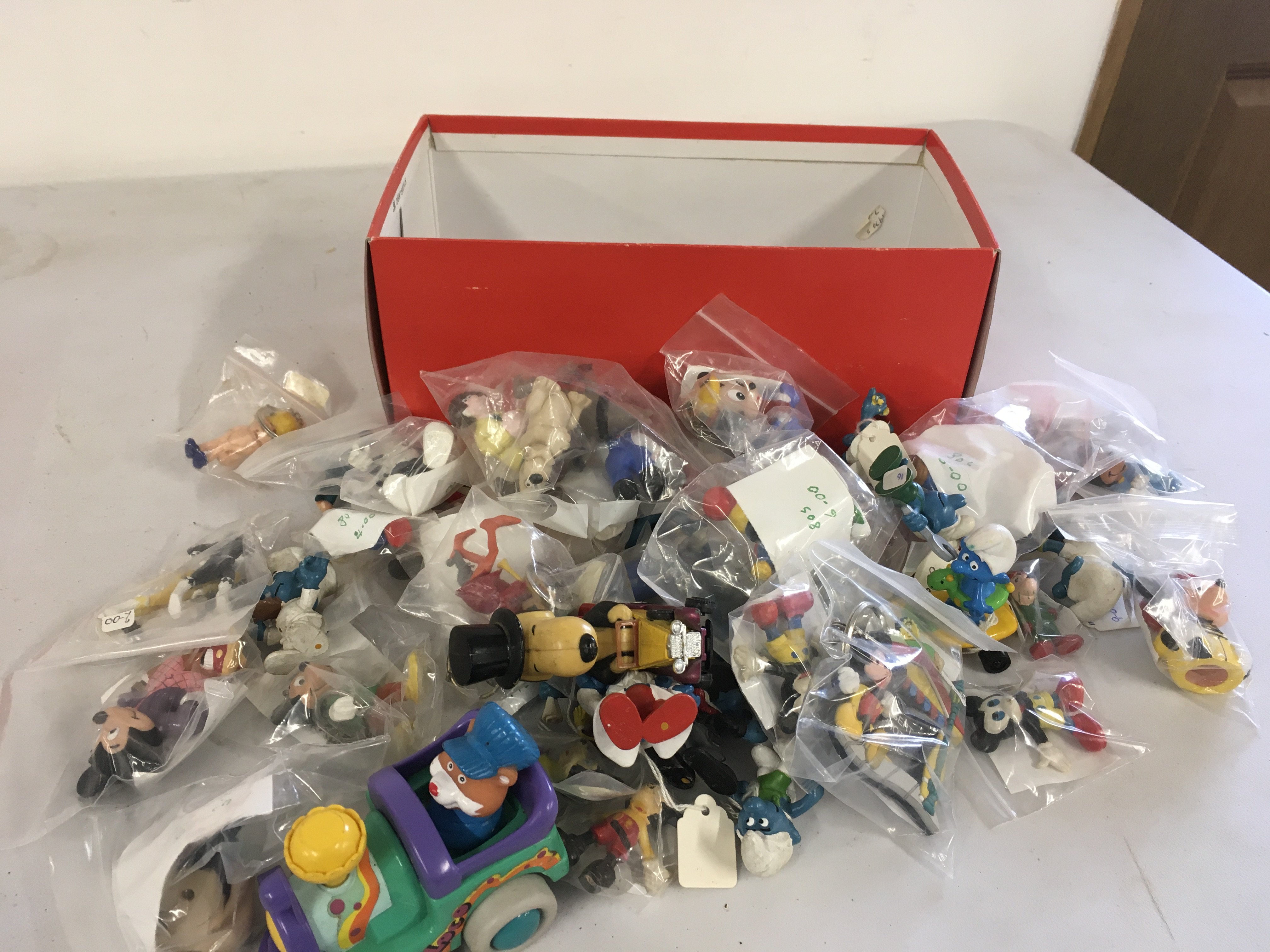 A box containing in excess of 35 figures featuring Smurfs..Mickey Mouse..Wallace and Grommit..power rangers etc. no reserve 