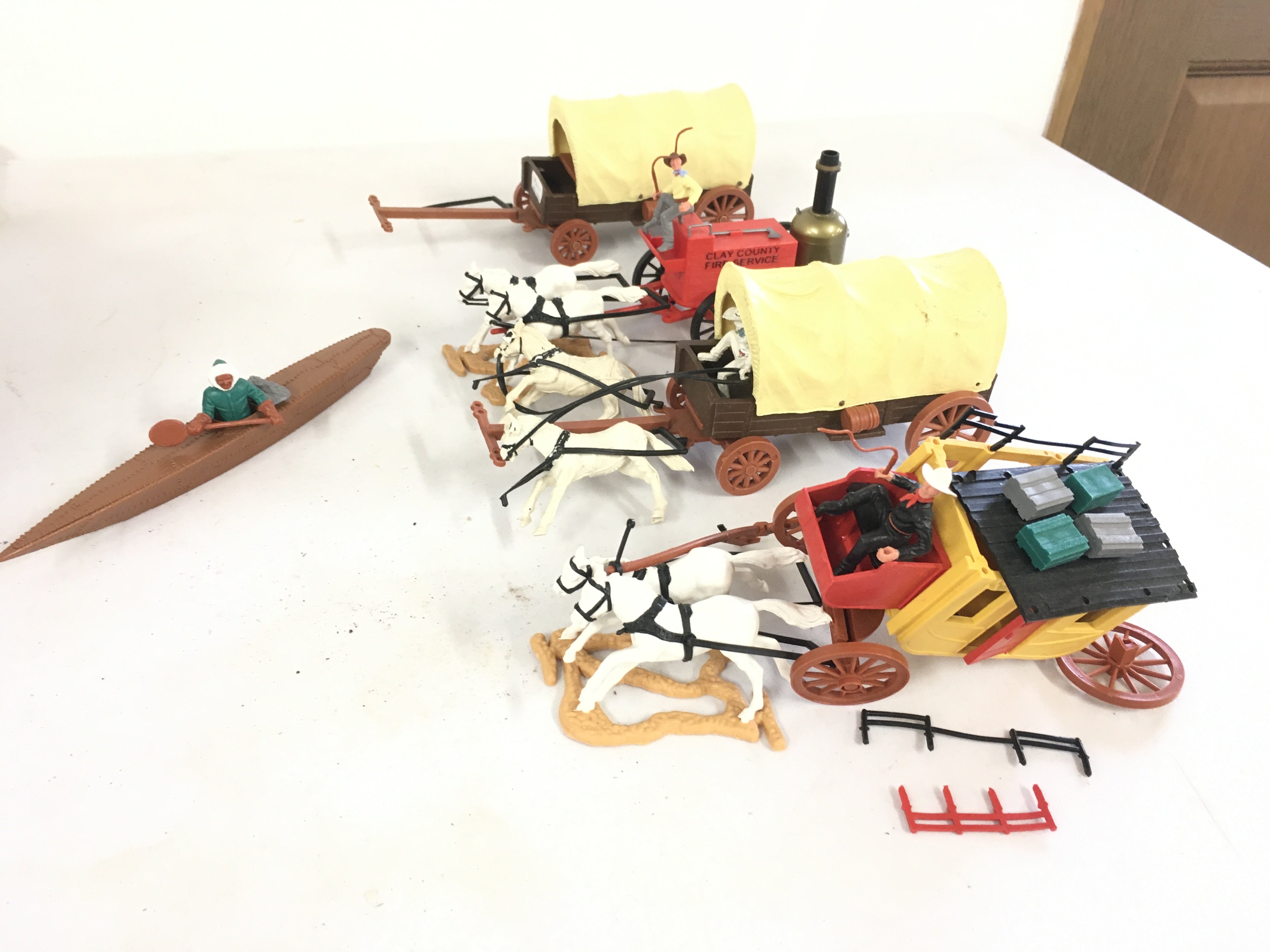 A selection of Timpo plastic models featuring wagons..horses..people..canoe.  Some damage.  No reserve